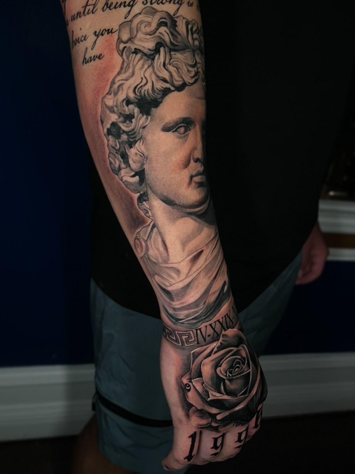 Statue head and rose realism tattoo on the forearm by Angie Morales, Laredo, Texas