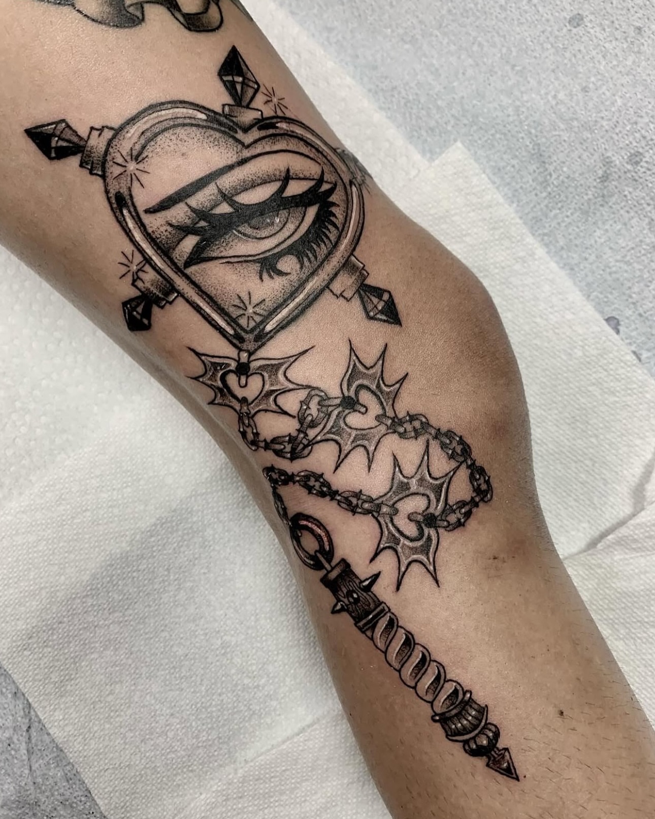 Heart with eye dotwork tattoo on the forearm by Xena