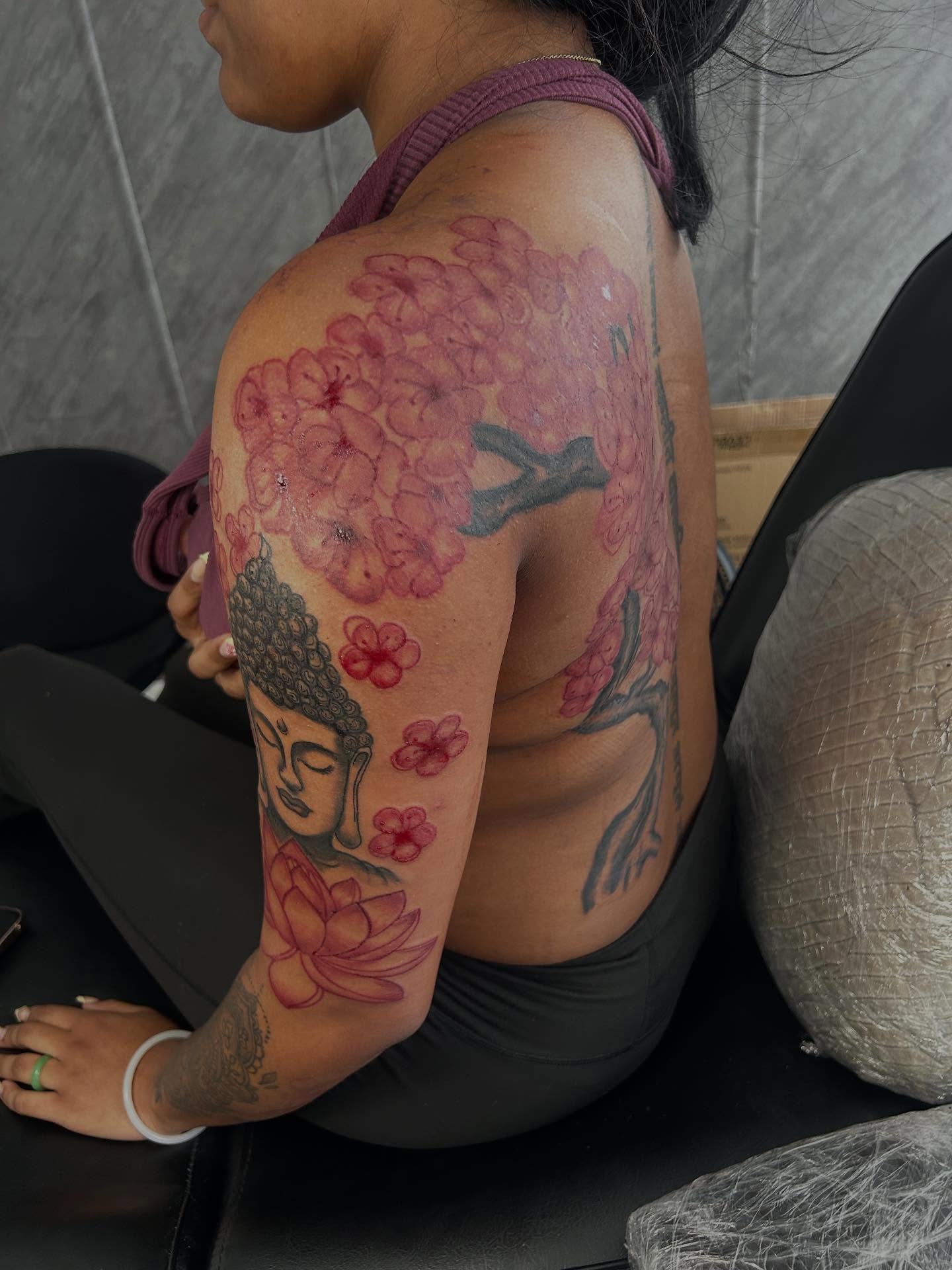 Cherry blossoms and Buddha neo-traditional tattoo on the shoulder by nylachanel