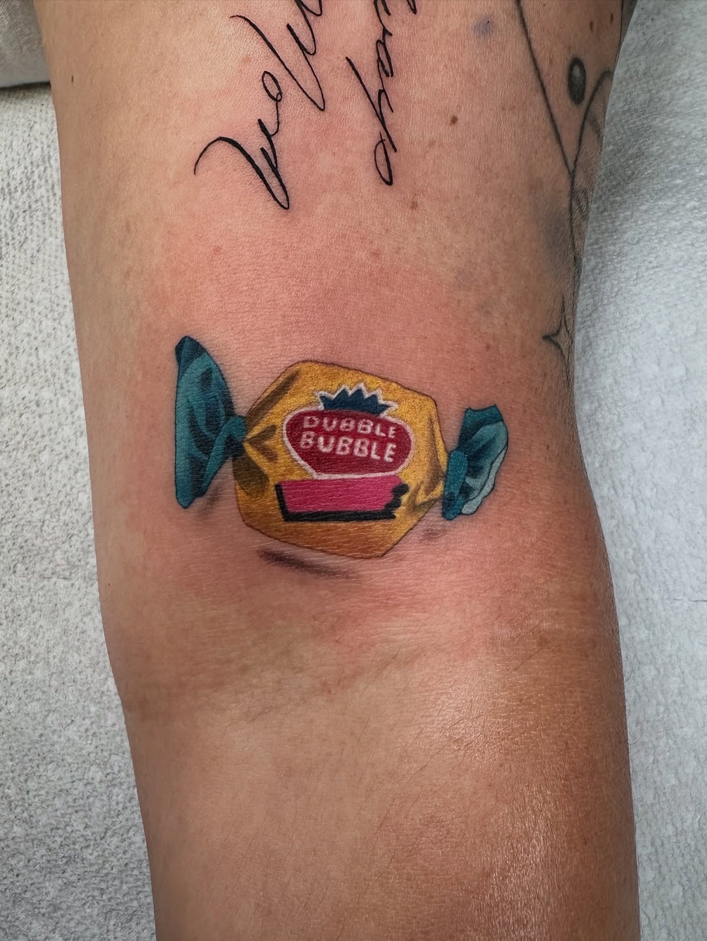 Dubble bubble gum wrapper American traditional tattoo on the forearm by Savannah Compton