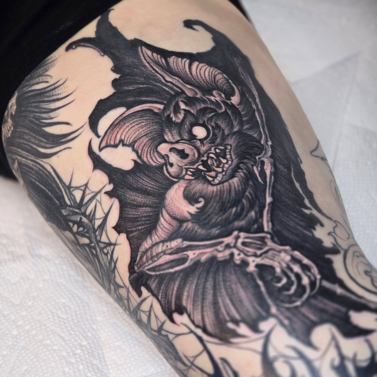 Demon dark realism tattoo on the thigh by Barrett Handel