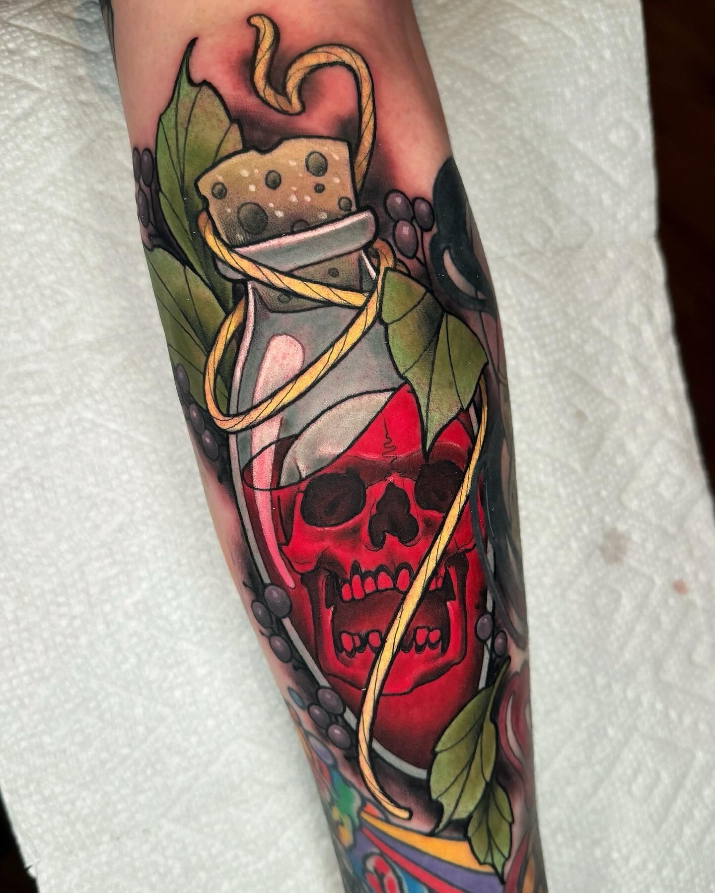 Skull in bottle dotwork tattoo on the forearm by Austin Britt