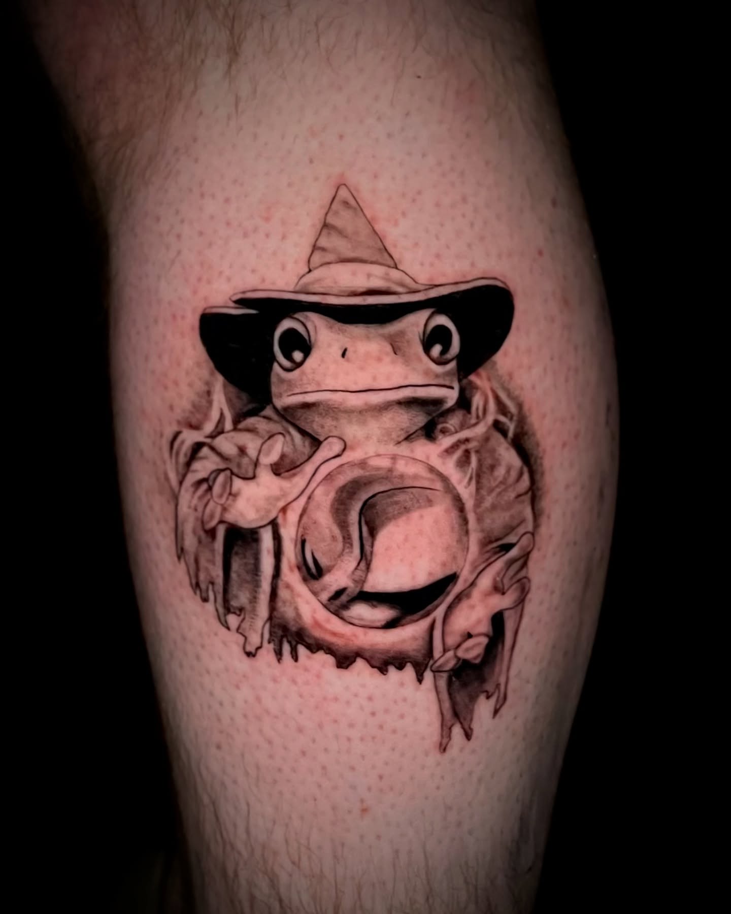 Frog wearing hat black and grey tattoo on the forearm by Jake, Salt Lake City, Utah