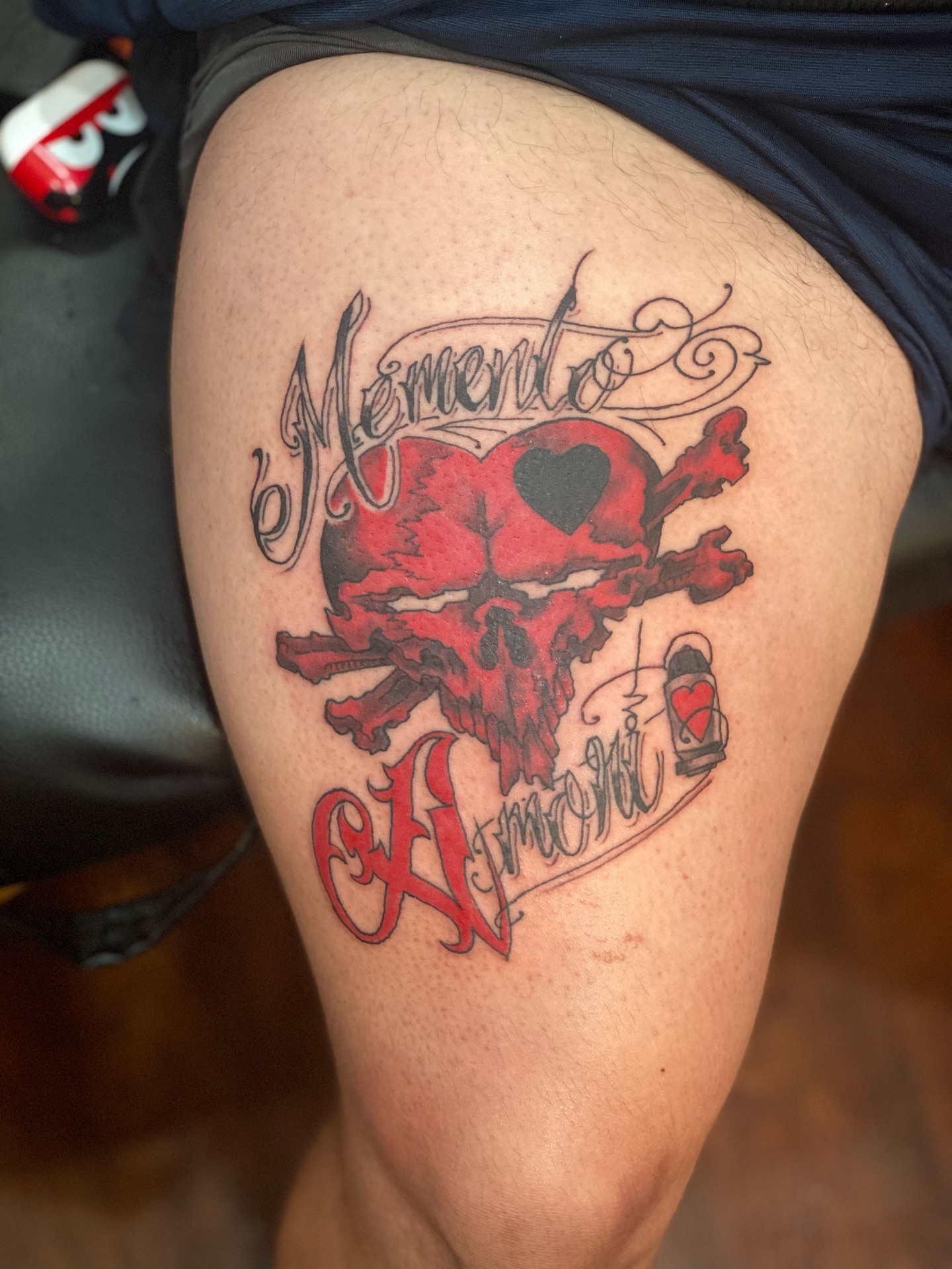 Skull and heart American traditional tattoo on the thigh by Christopher Sanders
