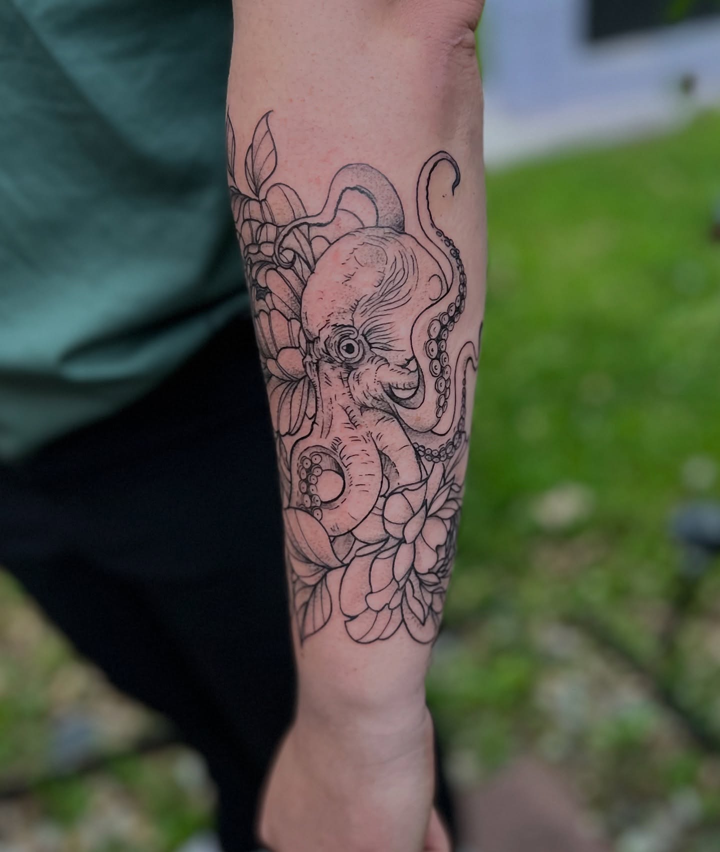 Octopus and floral black and grey tattoo on the forearm by Rose DeLisse