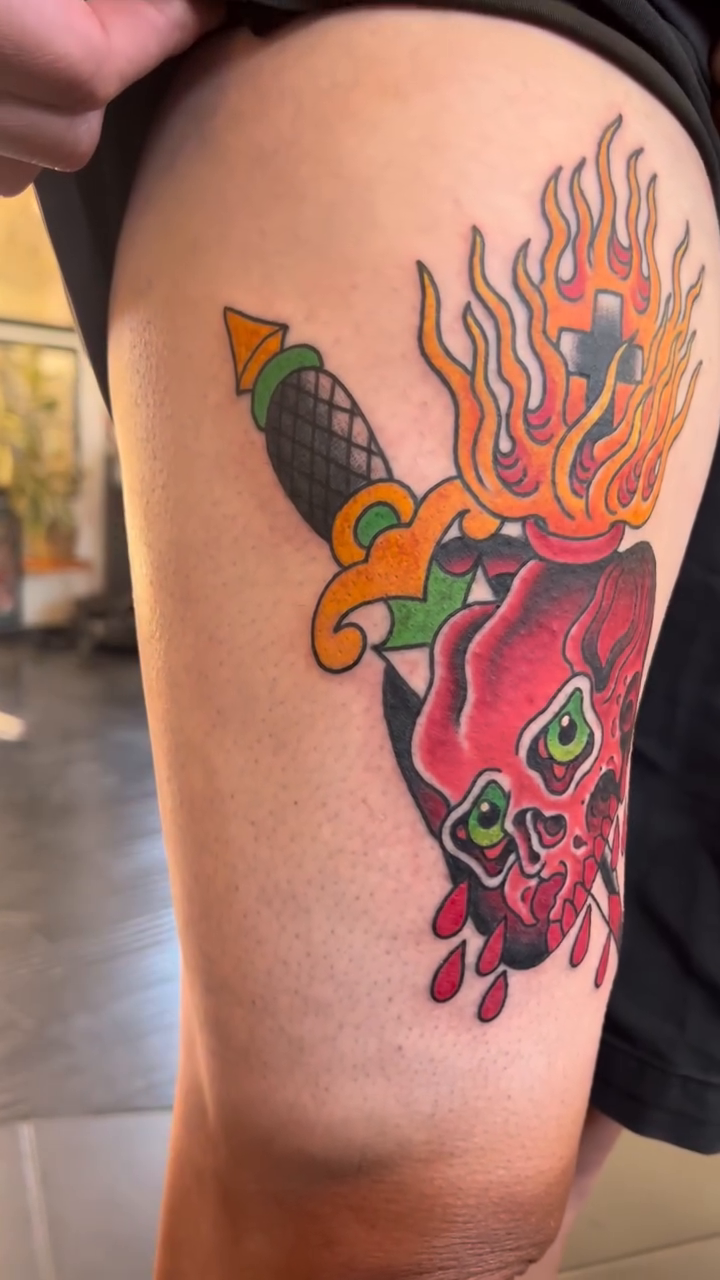 Flaming heart with skull and dagger neo-traditional tattoo by Kayle Leogrande