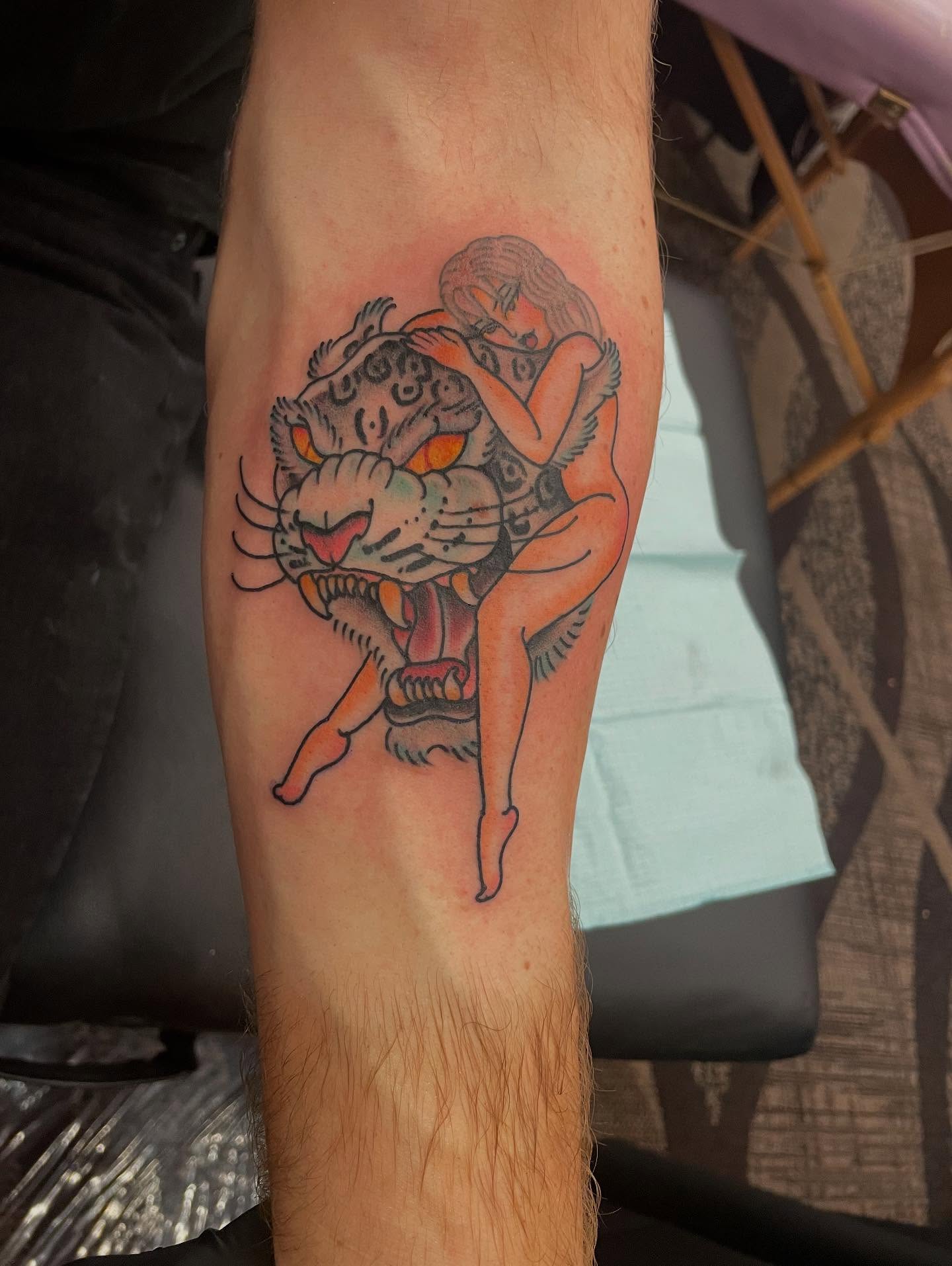 Tiger and woman American traditional tattoo on the forearm by Mika Clairissa