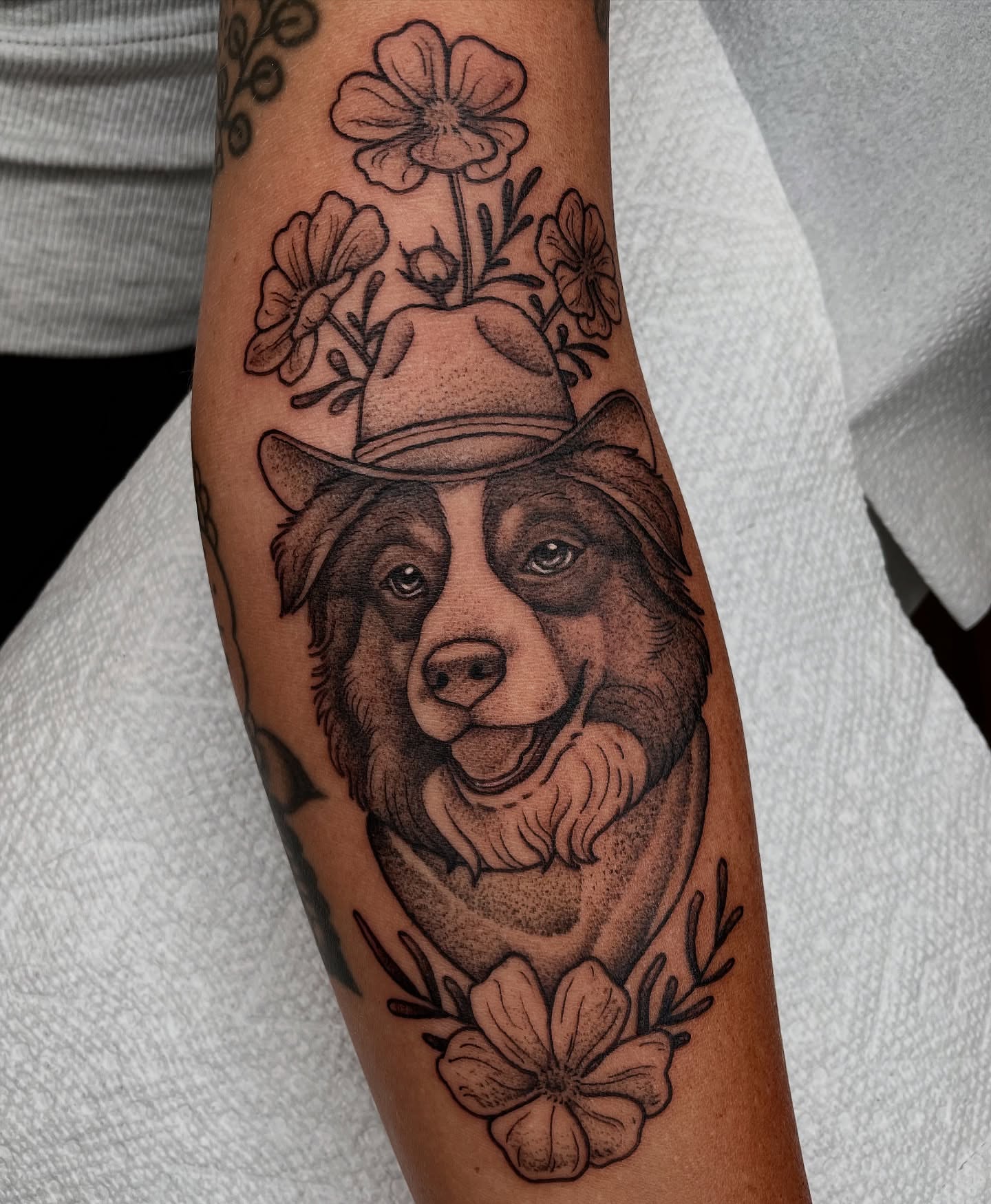 Bear wearing hat realism tattoo on the forearm by Emily Lux
