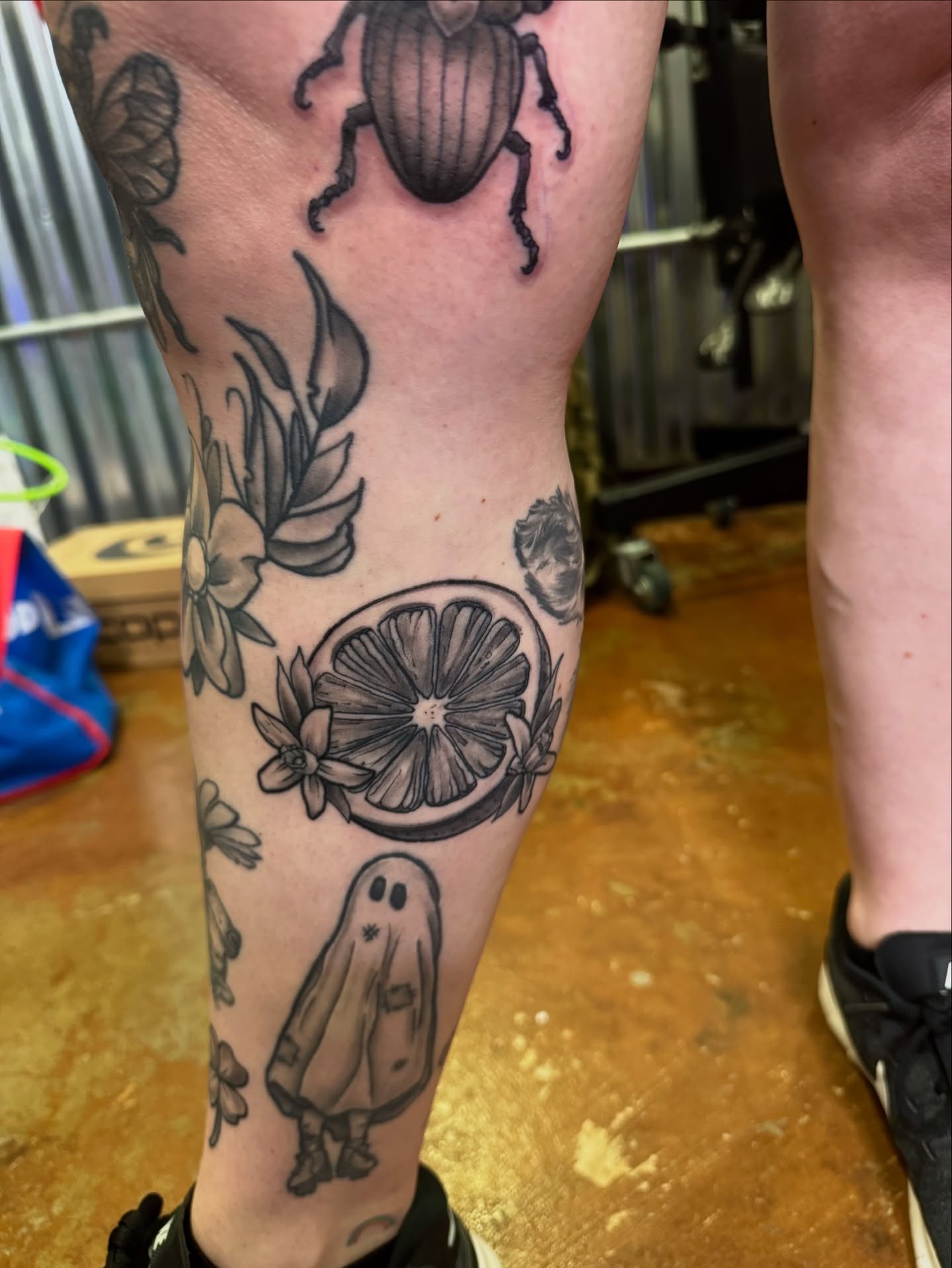 Fruit and ghost black and grey tattoo on the calf by David C. McGhee