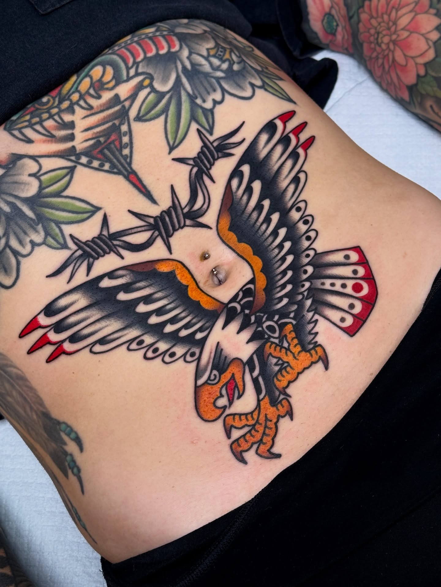 Bird with barbed wire American traditional tattoo on the thigh by Jordan Allen