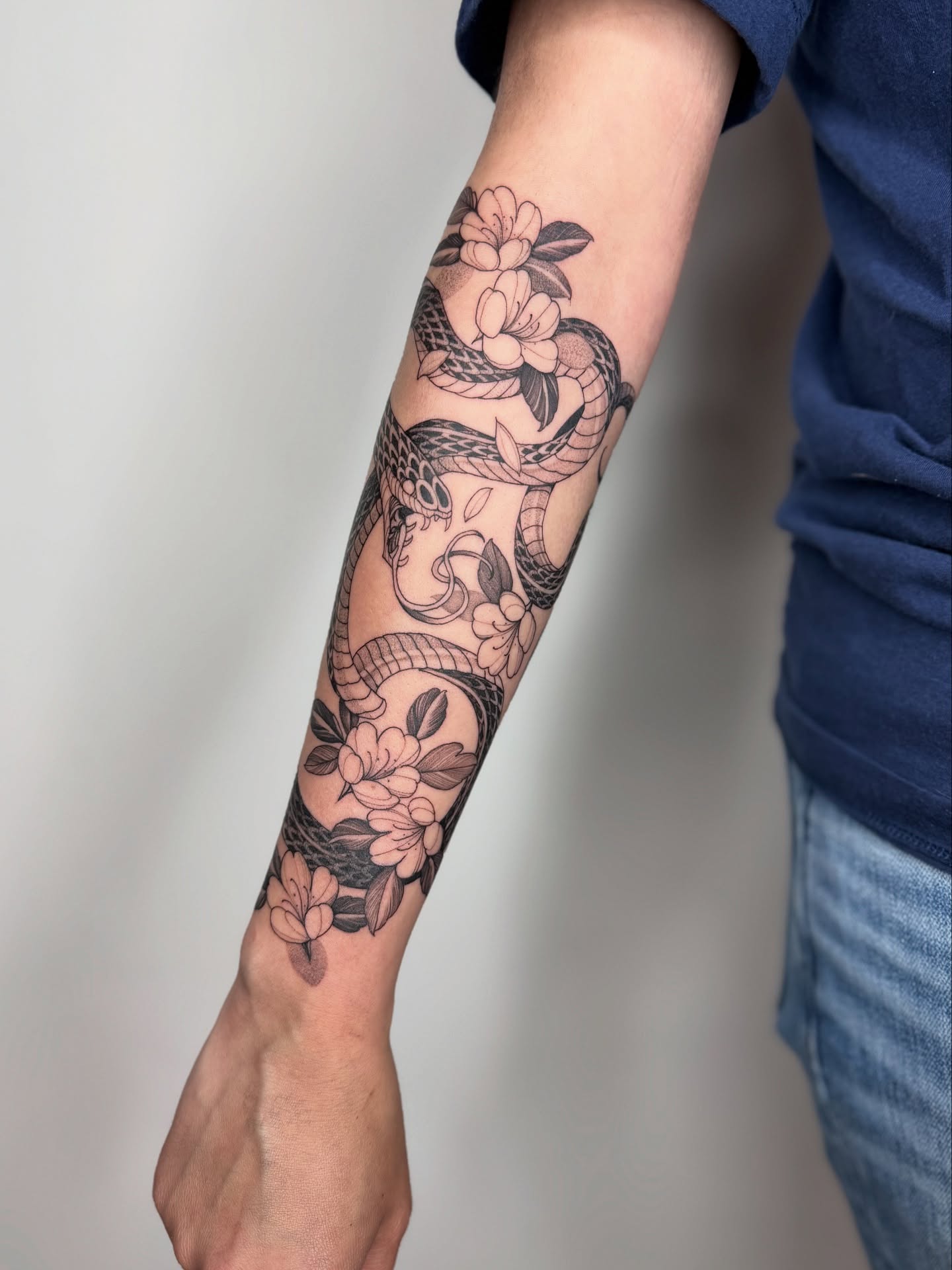 Snake and flowers American traditional tattoo on the forearm by 🥀michael Ta 🥀