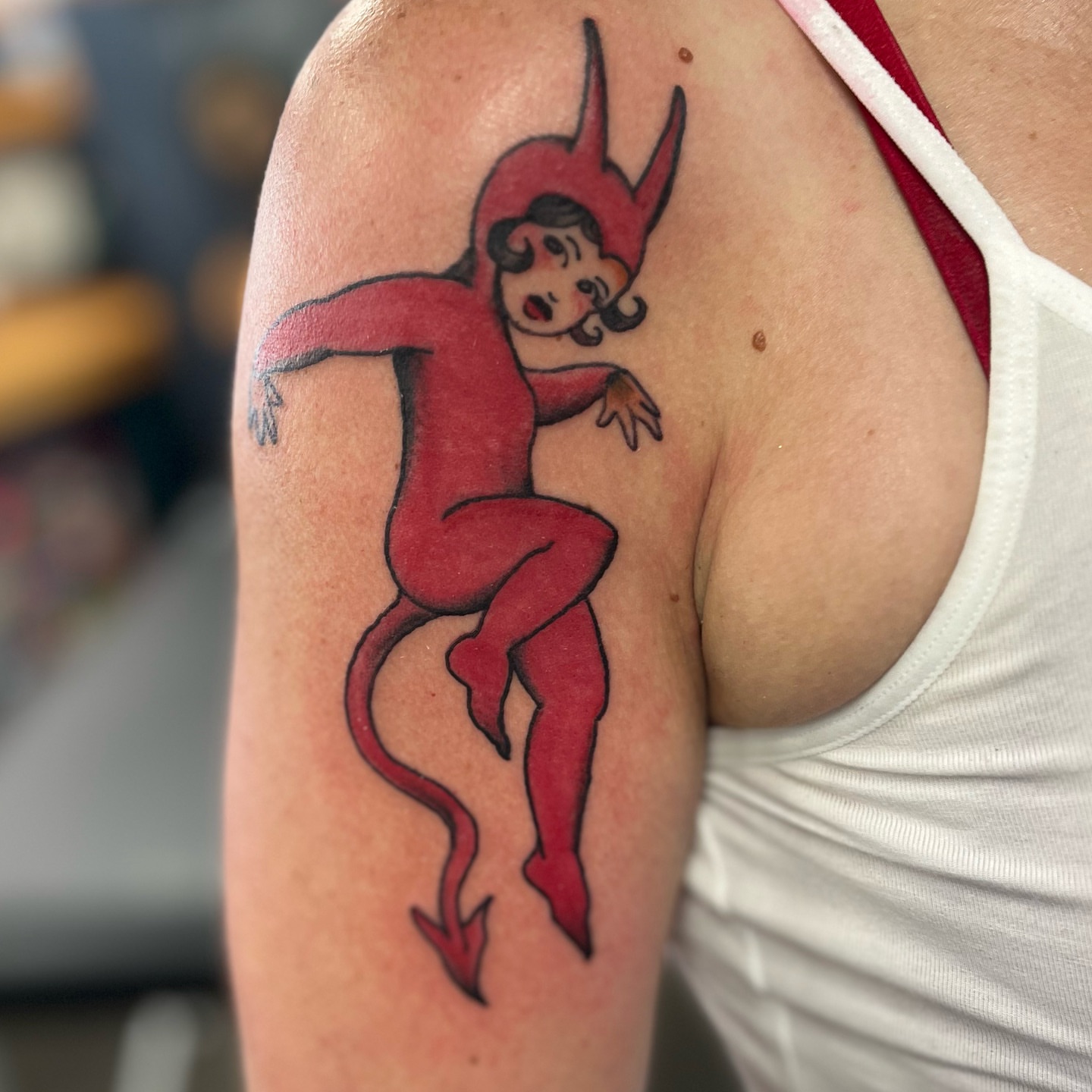 Red devil American traditional tattoo on the shoulder by Ashley Camp