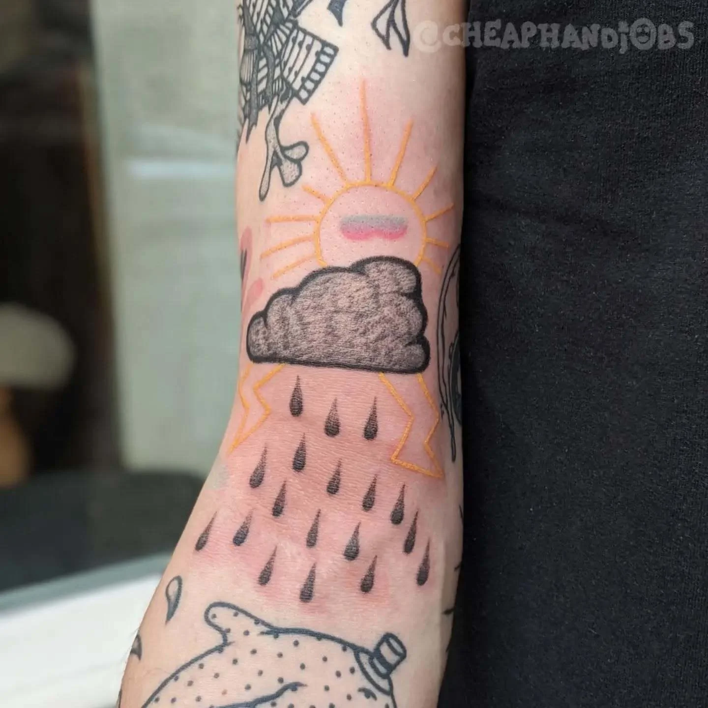 Rain cloud and sun dotwork tattoo on the forearm by @cheaphandjobs, Leipzig, Germany