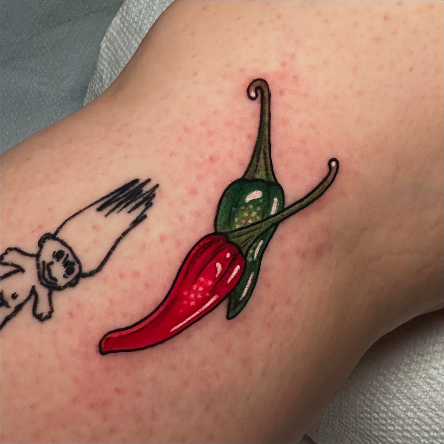 Chili peppers realism tattoo on the forearm by Tayler Pearson, Fort Collins, Colorado