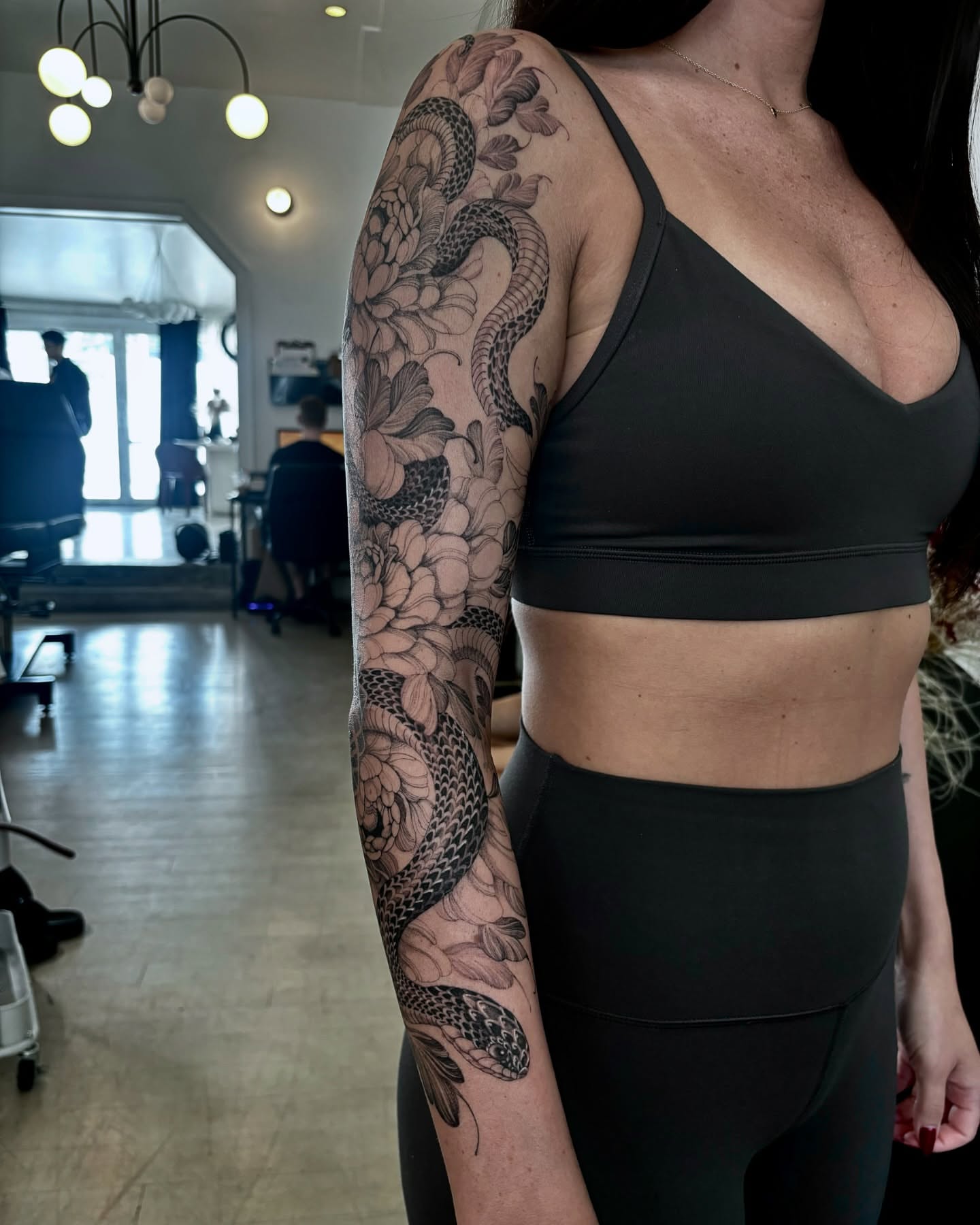 Snake and peony realism tattoo on the upper arm by Yongjun