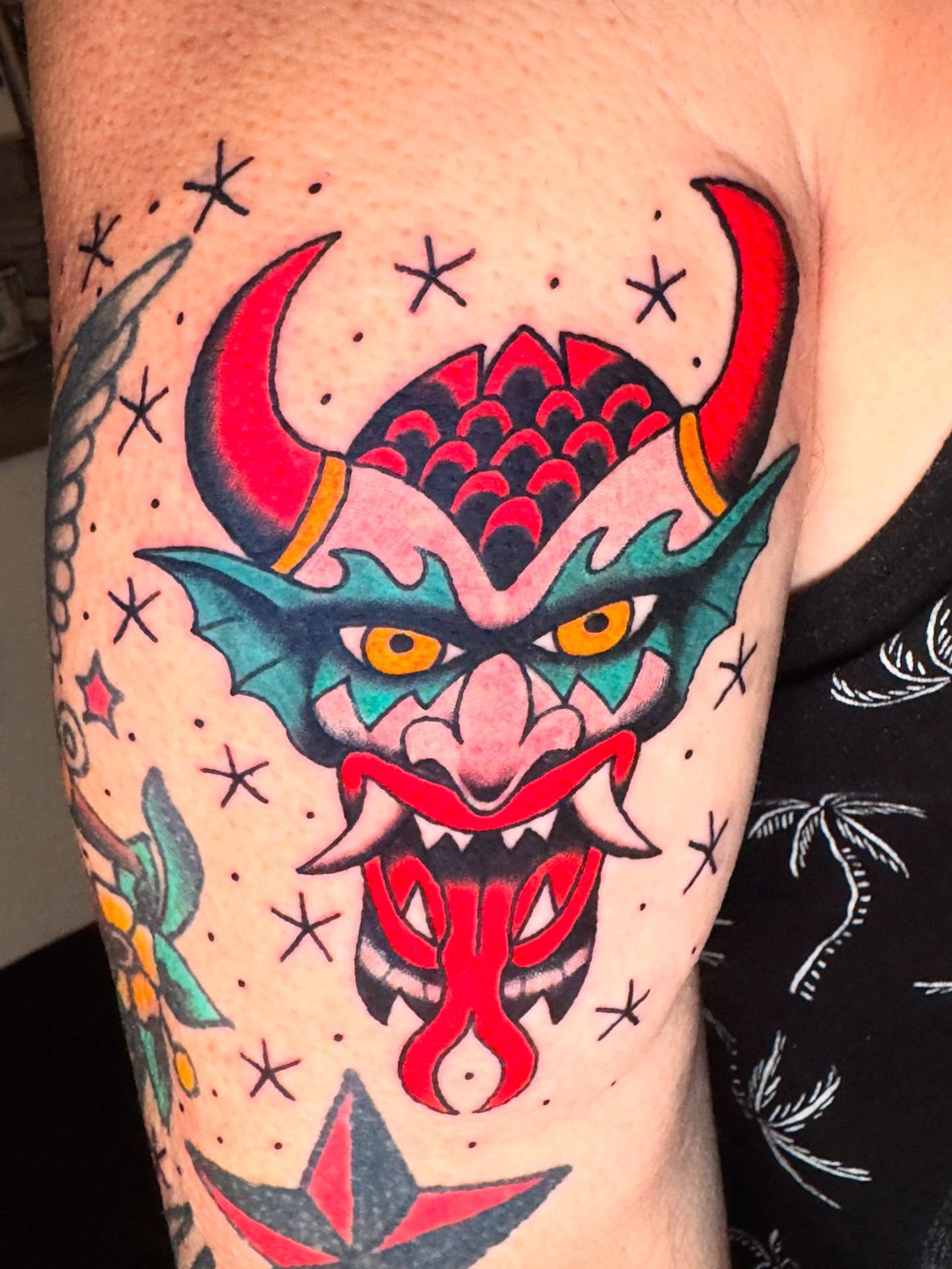 Demon mask American traditional tattoo on the forearm by Eric Zuluaga