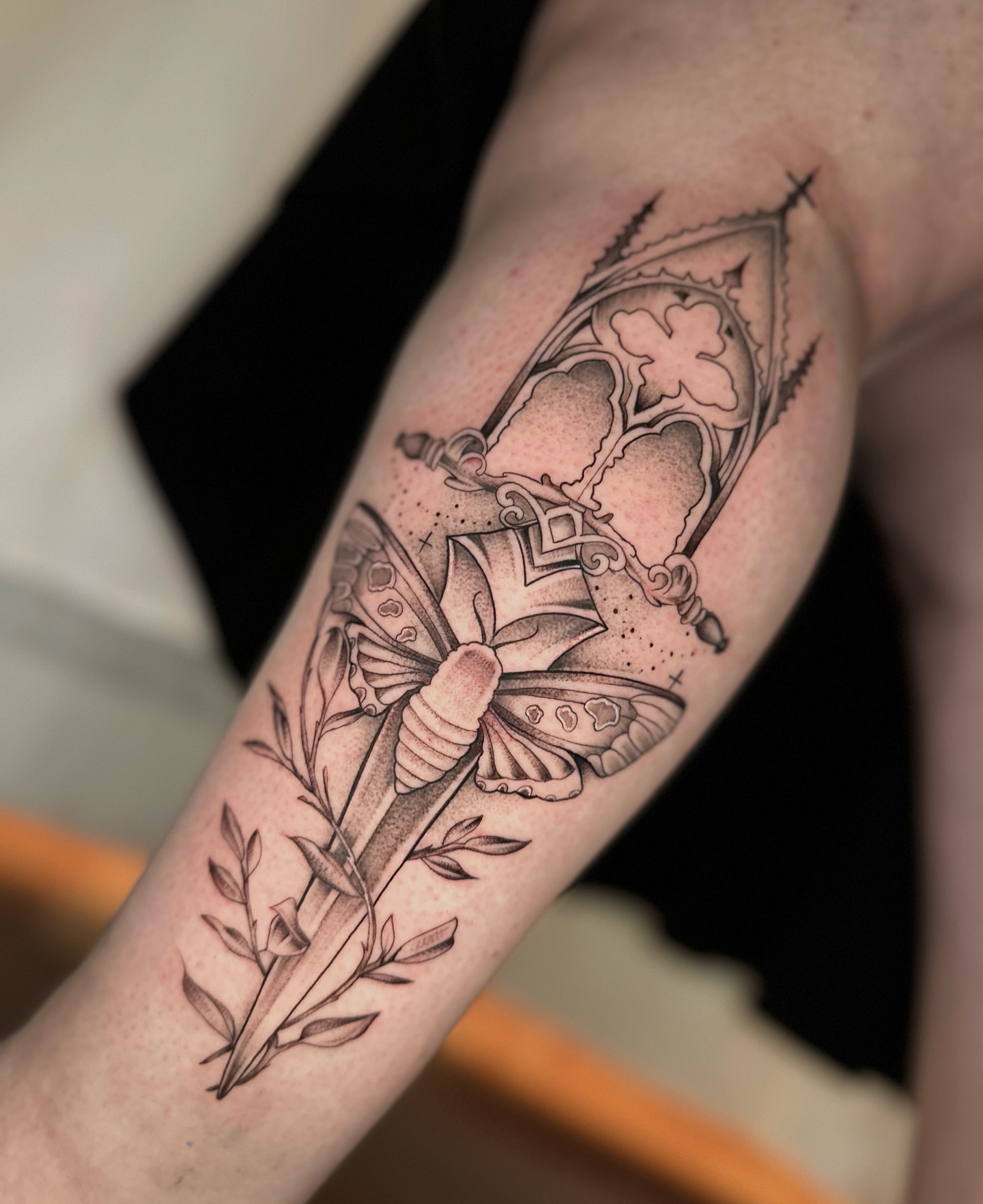 Butterfly and crown dotwork tattoo on the forearm by zoe mars