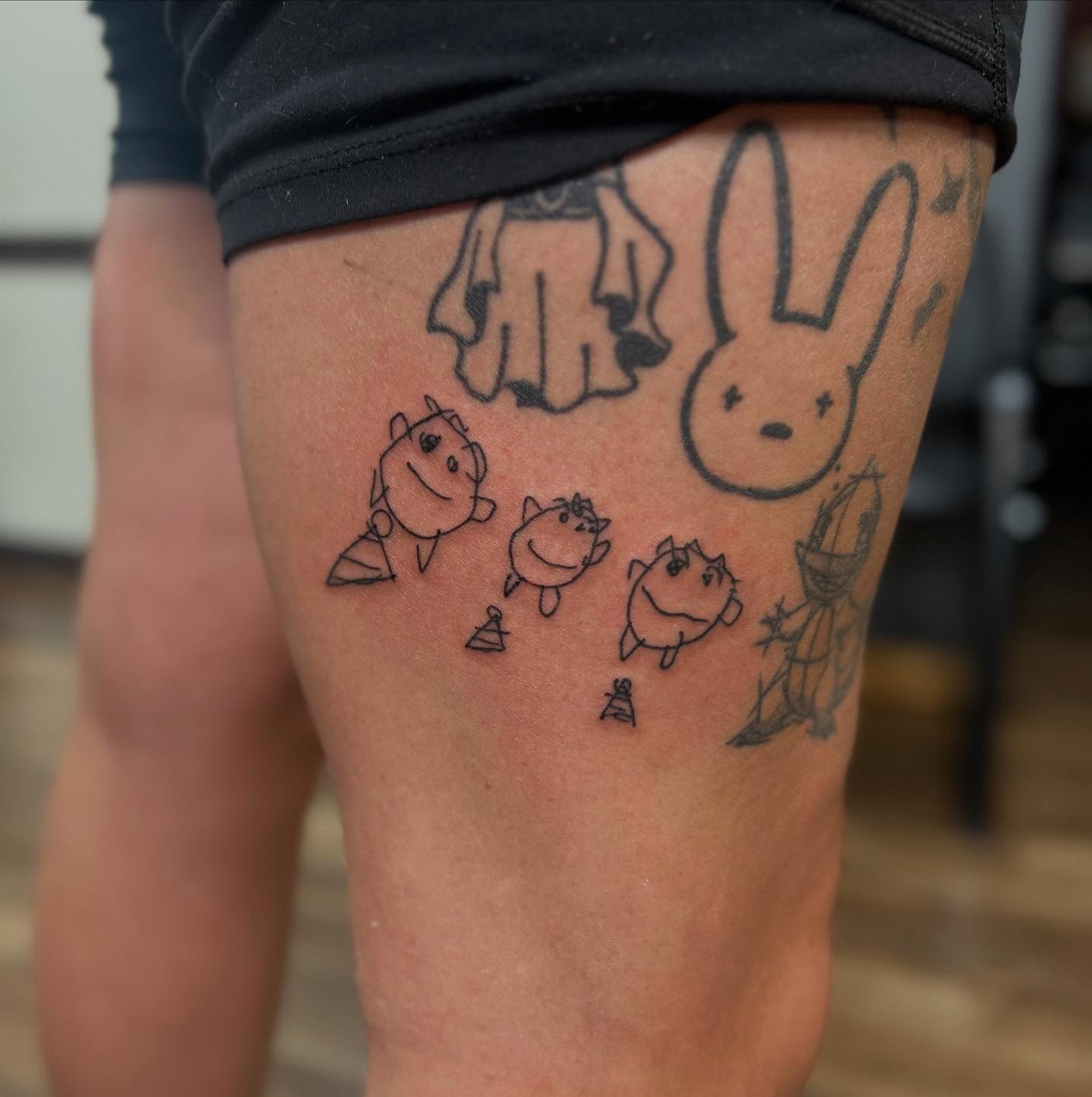 Cartoon characters minimalist tattoo on the thigh by Abby Camacho - Tattoo Artist and Piercer โจ๐