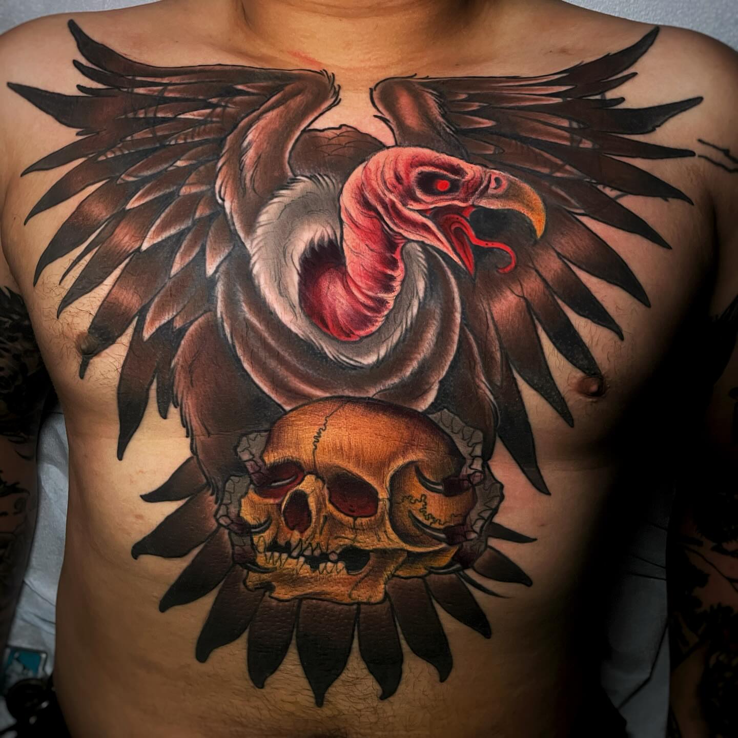 Vulture and skull realism tattoo on the chest by Ick Abrams