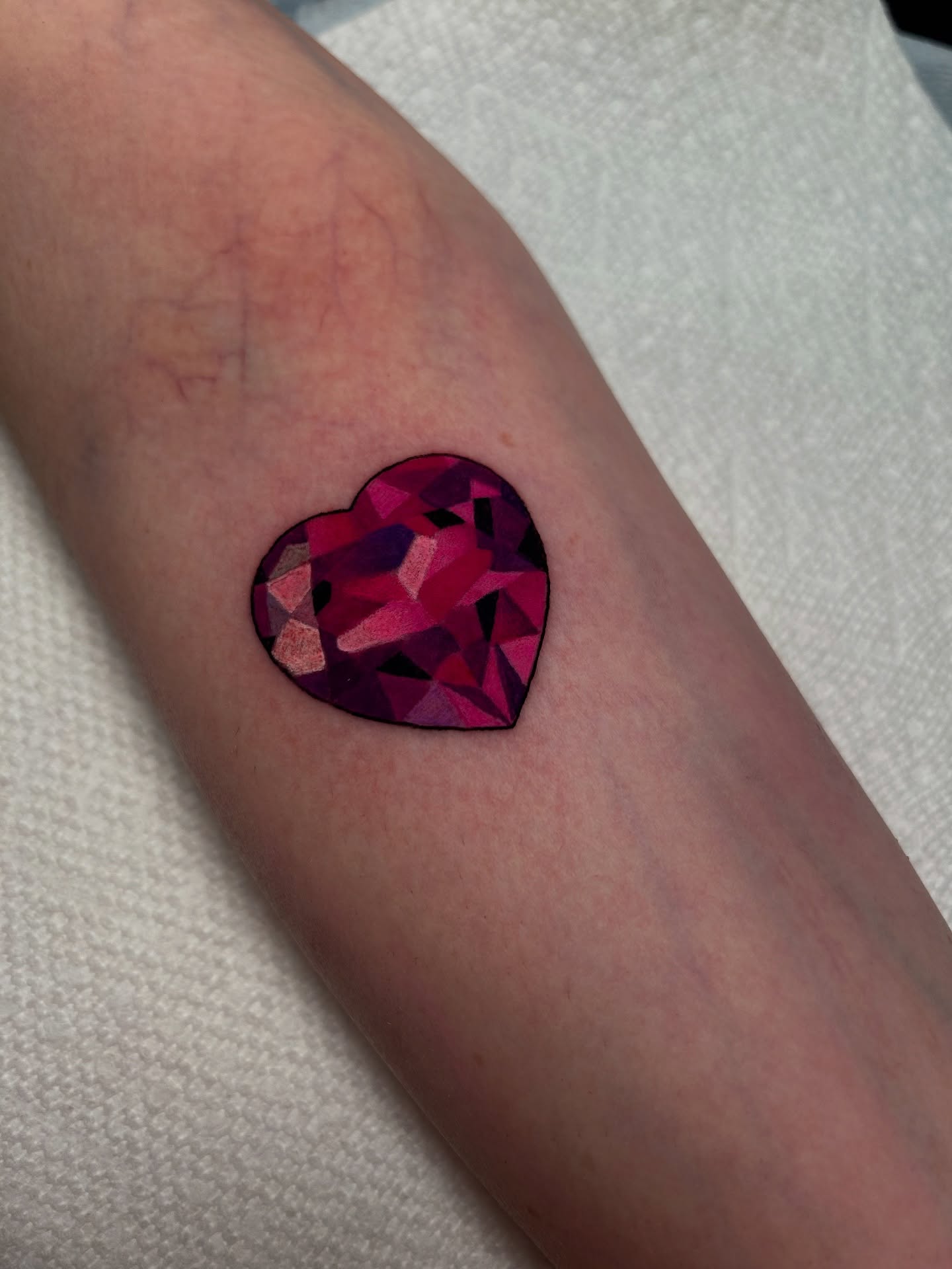 Geometric heart geometric tattoo on the forearm by Chloe Marie