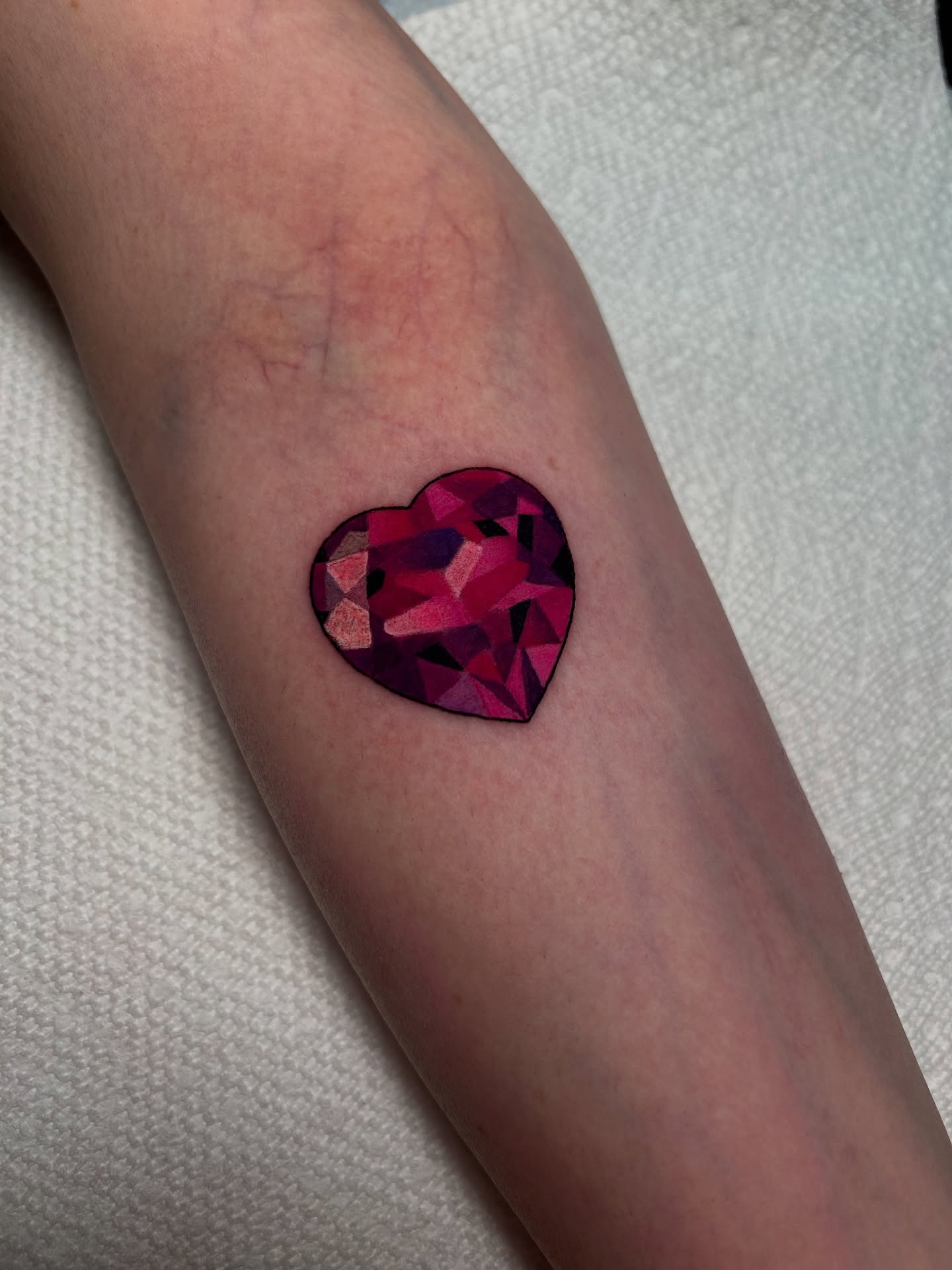 Geometric heart geometric tattoo on the forearm by Chloe Marie