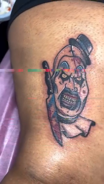 Creepy clown with knife realism tattoo by Eli Flores