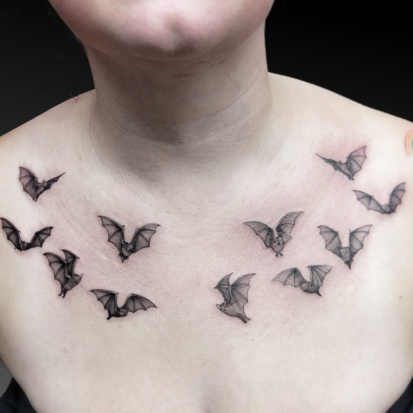 Bat swarm black and grey tattoo on the chest by Arick Reese