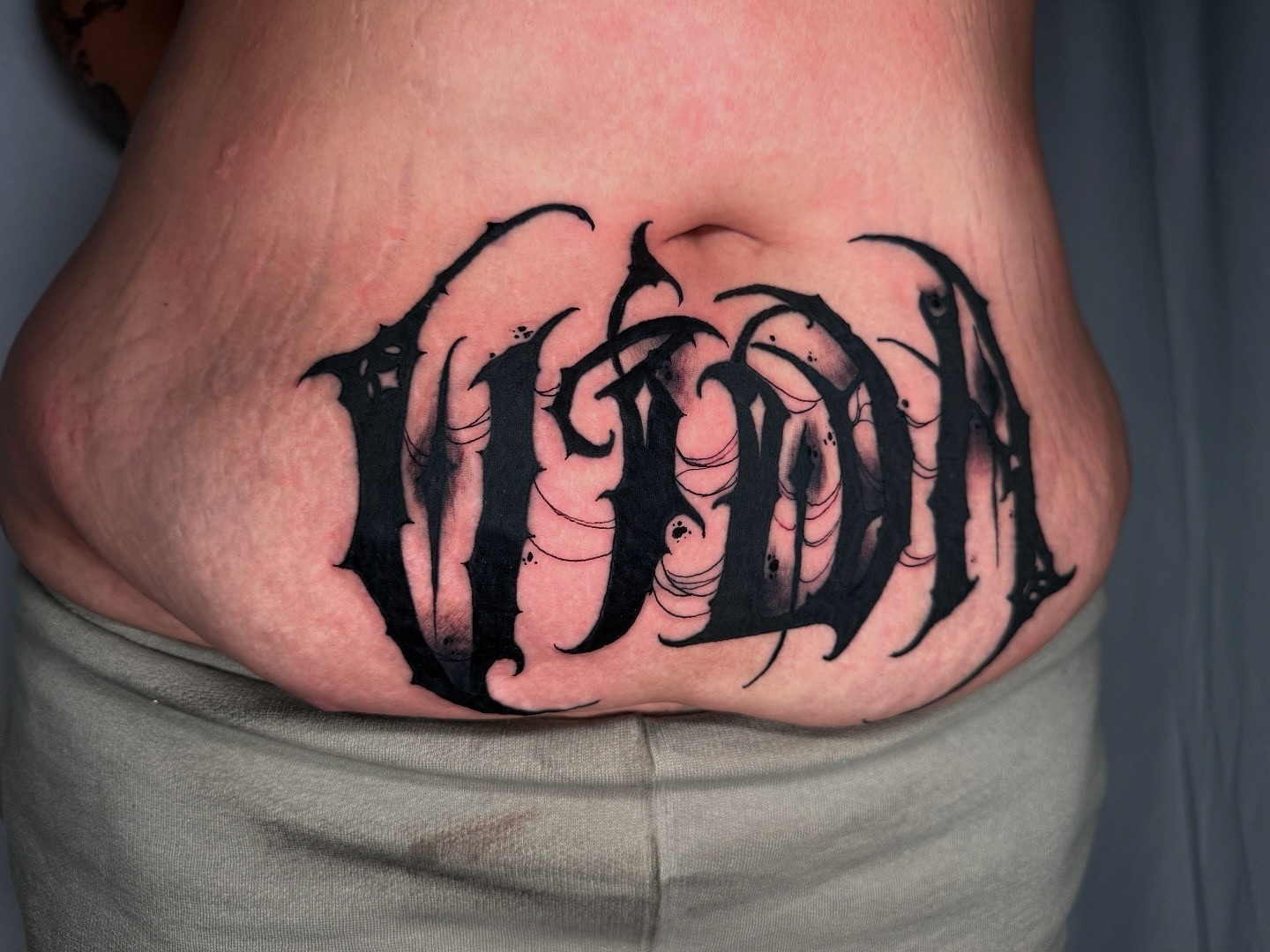 Gothic script lettering script tattoo on the torso by S C A B B e R W O C K y