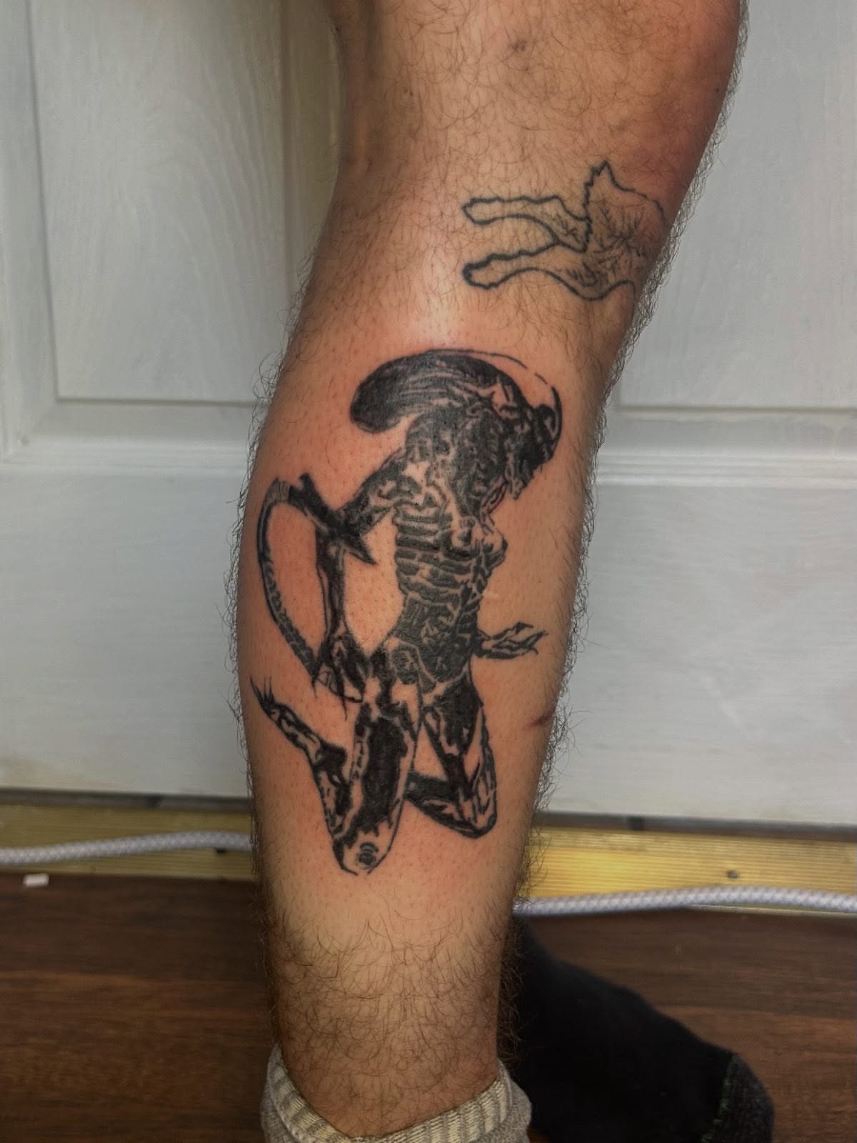 Alien creature black and grey tattoo on the calf by (isa)ac ૮₍ ˃̵ࡇ˂̵ ₎ა