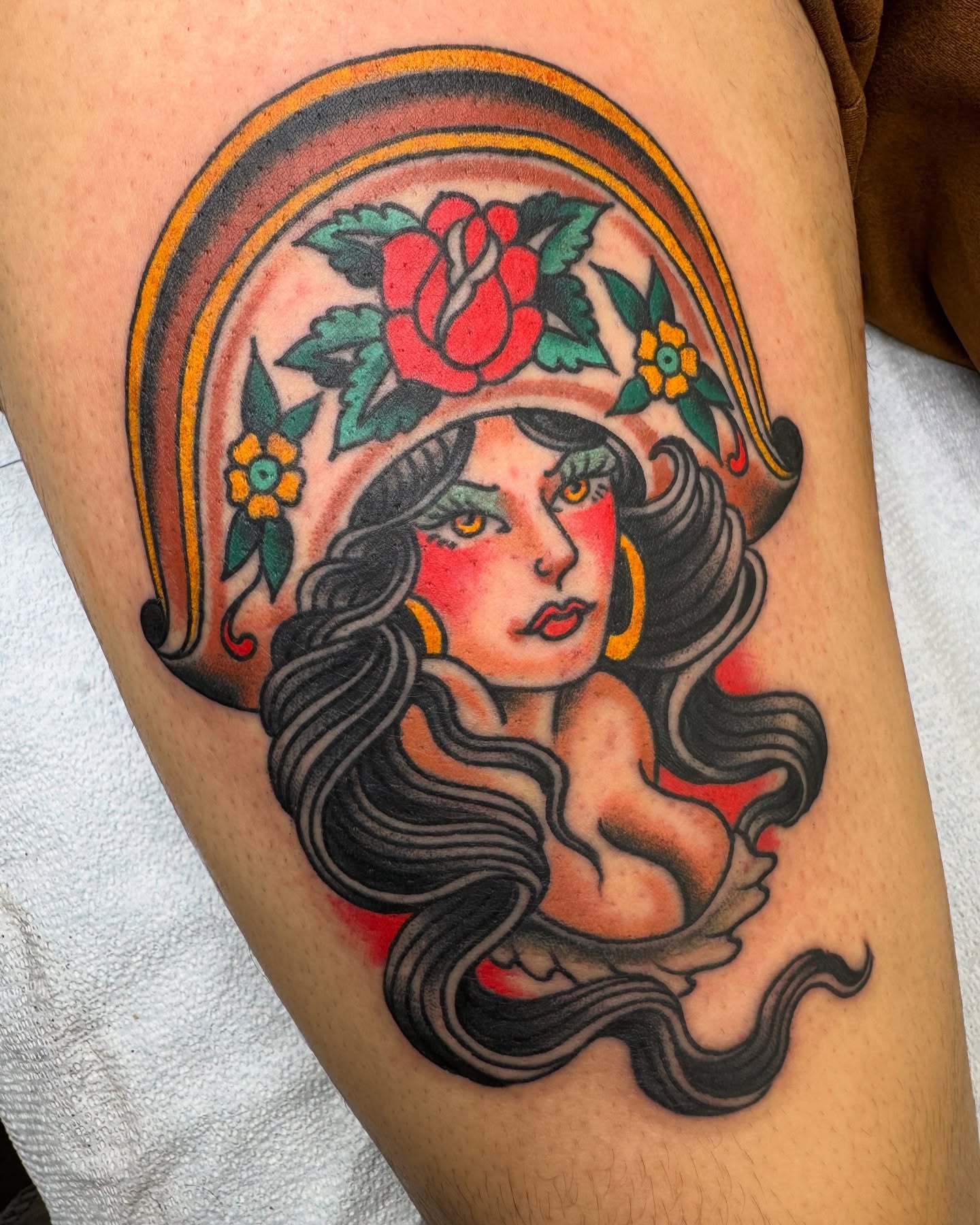 Woman with roses American traditional tattoo on the thigh by Ben Karnofsky