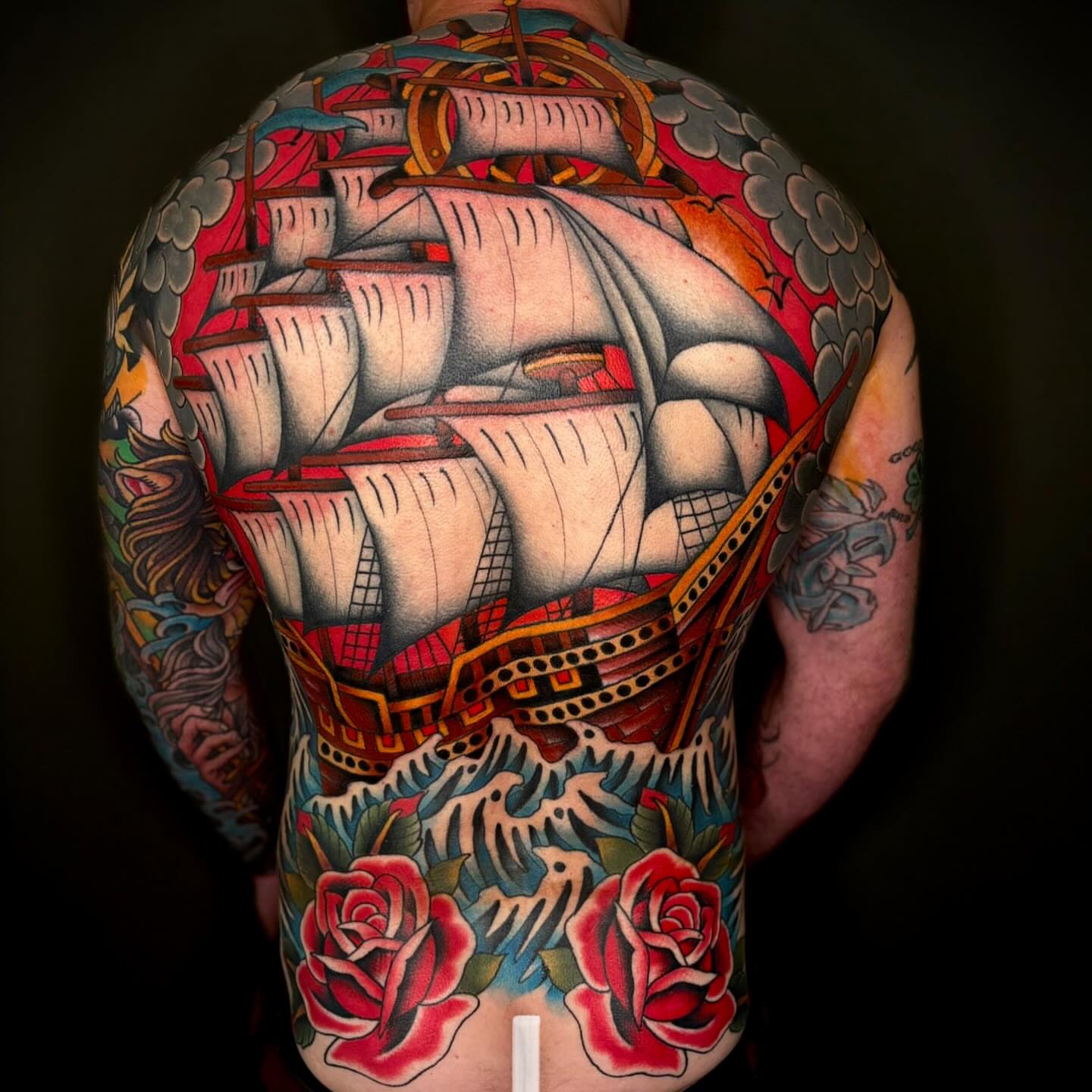 Ship and roses American traditional tattoo on the back by Cody Collins