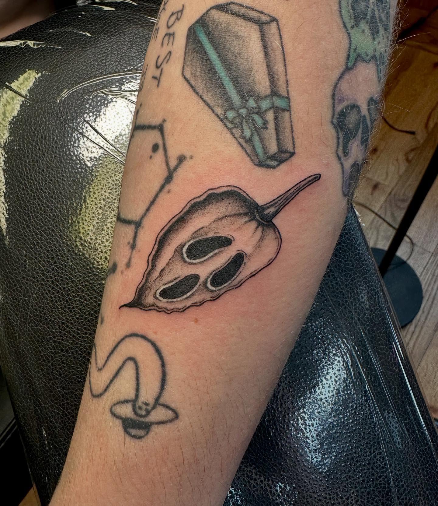 Calla lily and coffin black and grey tattoo on the forearm by Marie Novotny, Lakewood, Ohio