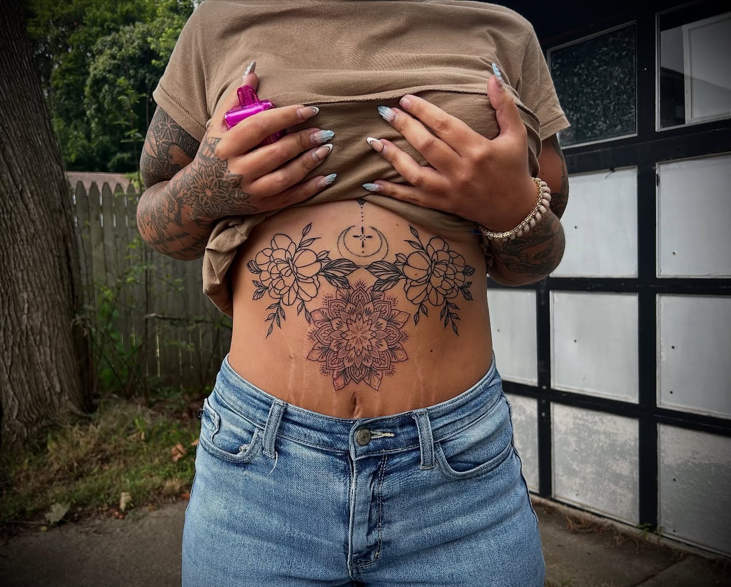 Mandala with flowers black and grey tattoo on the torso by Kiersten Tickle