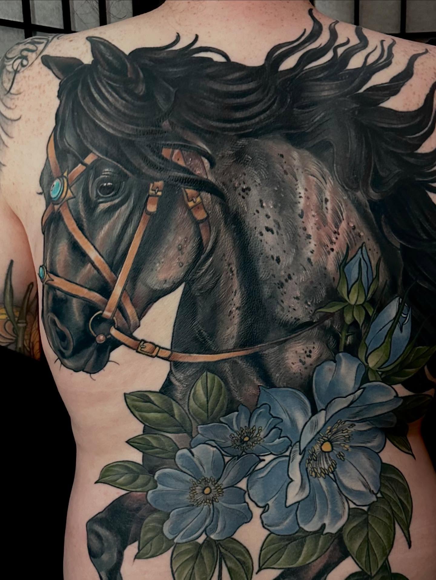 Horse and flowers realism tattoo on the back by Rachael Shelly