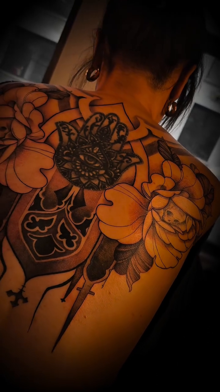 Ornamental crest with flowers geometric tattoo on the back by Nyc Tattoo Manhattan