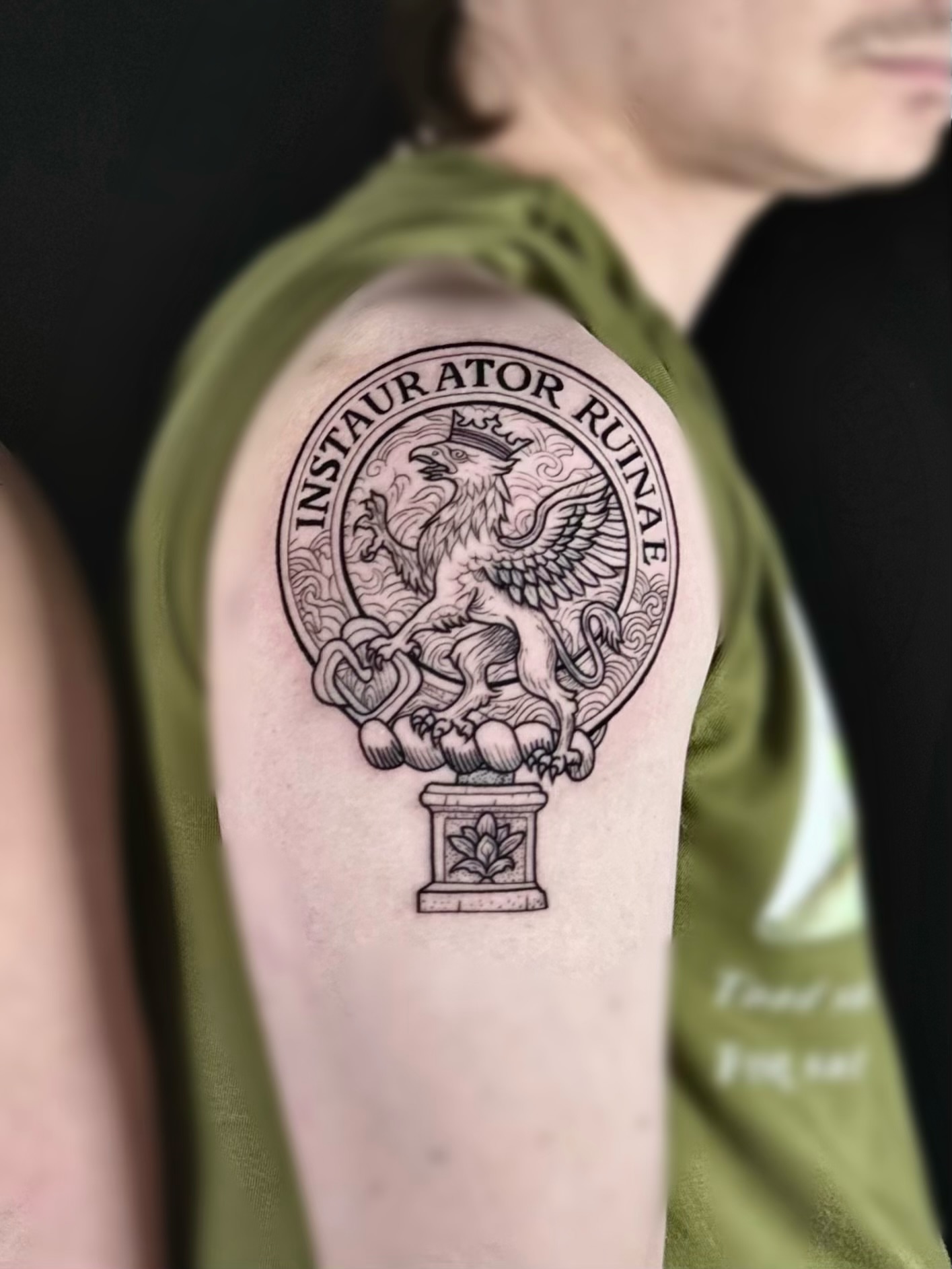 Griffin and shield black and grey tattoo on the forearm by Abi