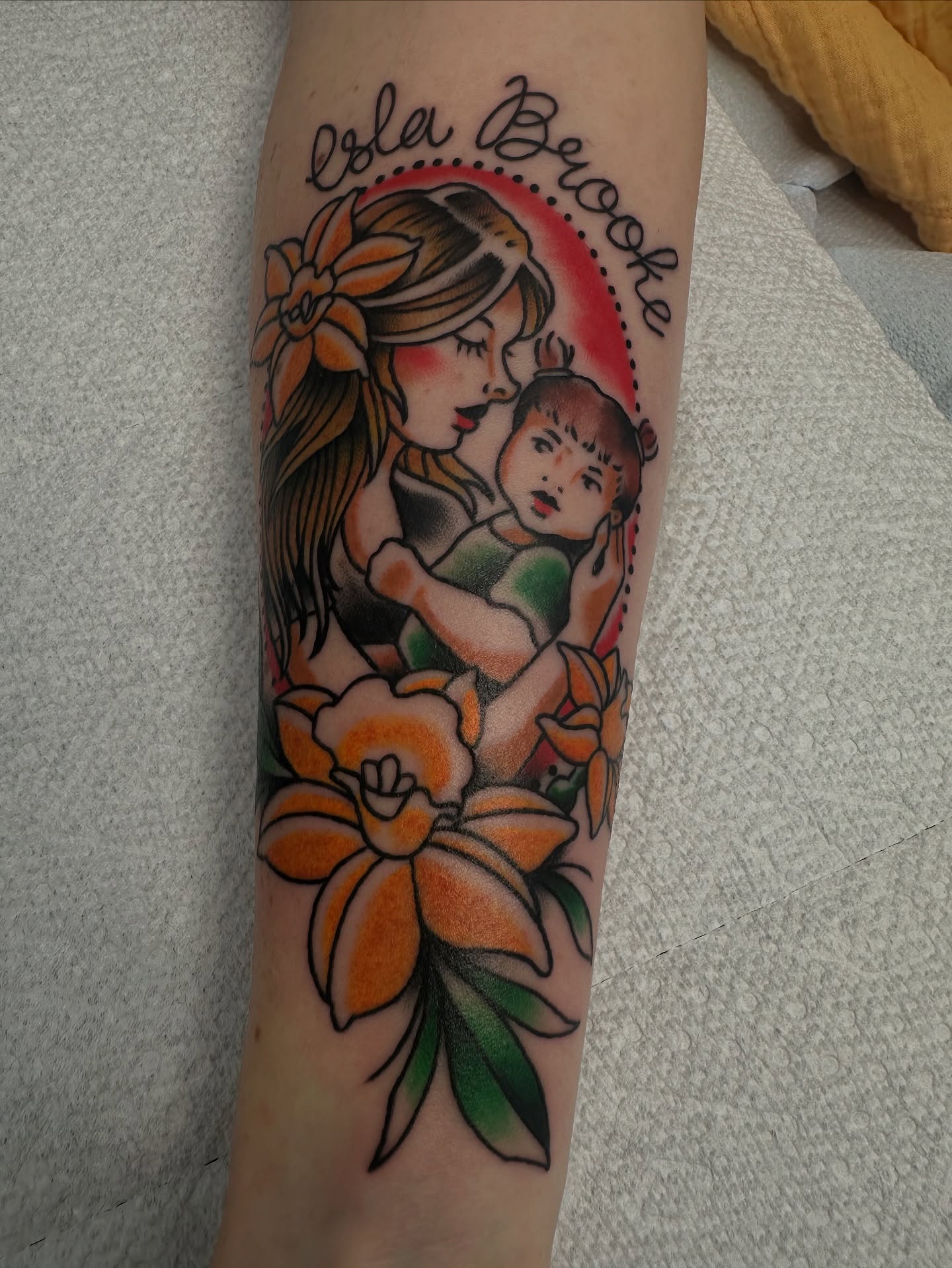 Mother and child American traditional tattoo on the forearm by Heather Cherish
