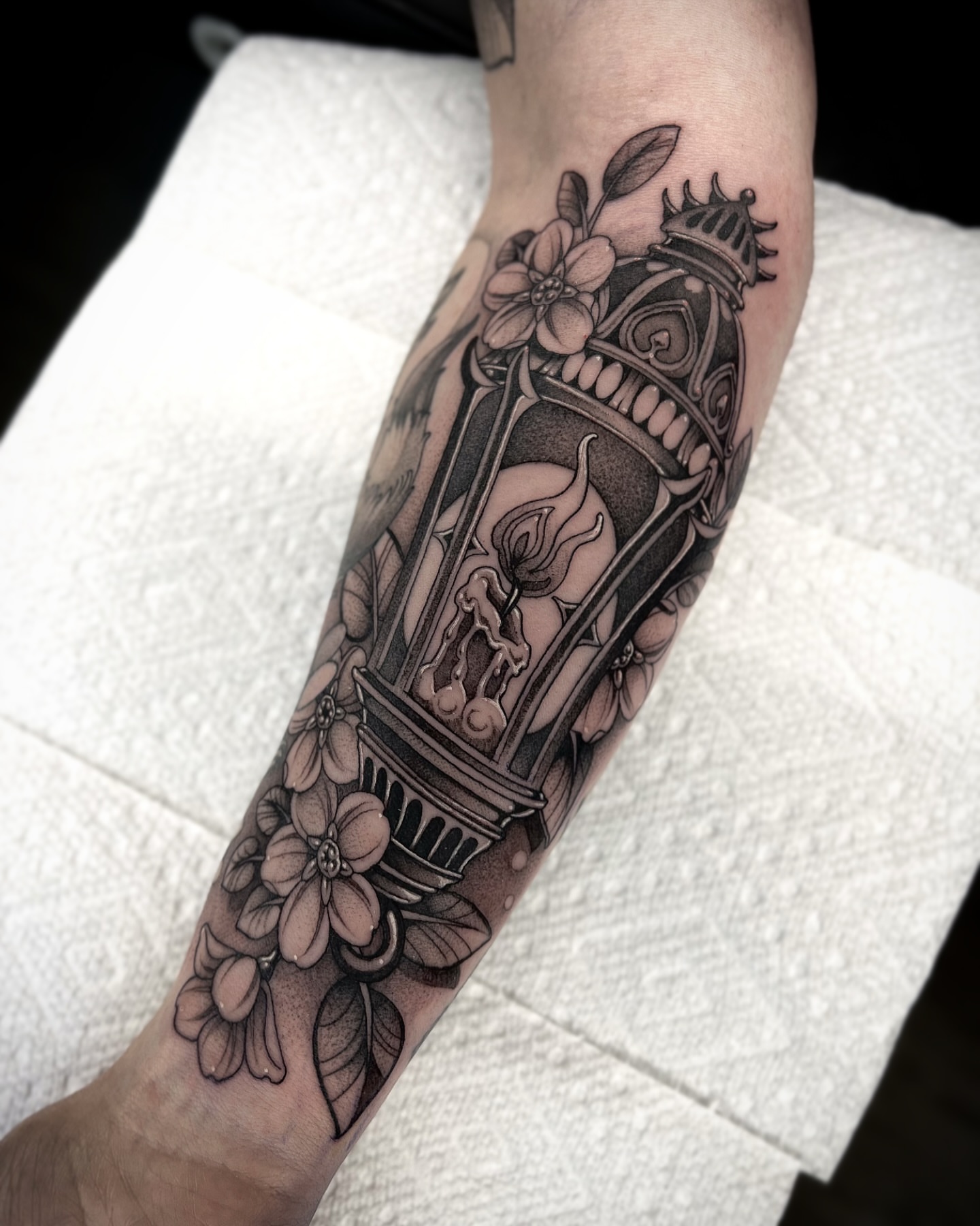 Candle lantern black and grey tattoo on the forearm by Kaysee Shuster