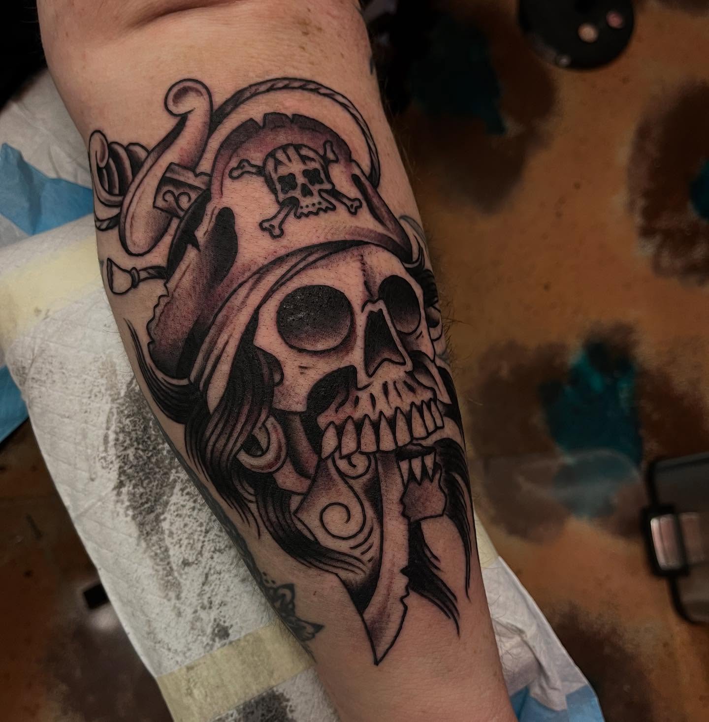Pirate skull black and grey tattoo on the forearm by Lee Brewster, Erlanger, Kentucky