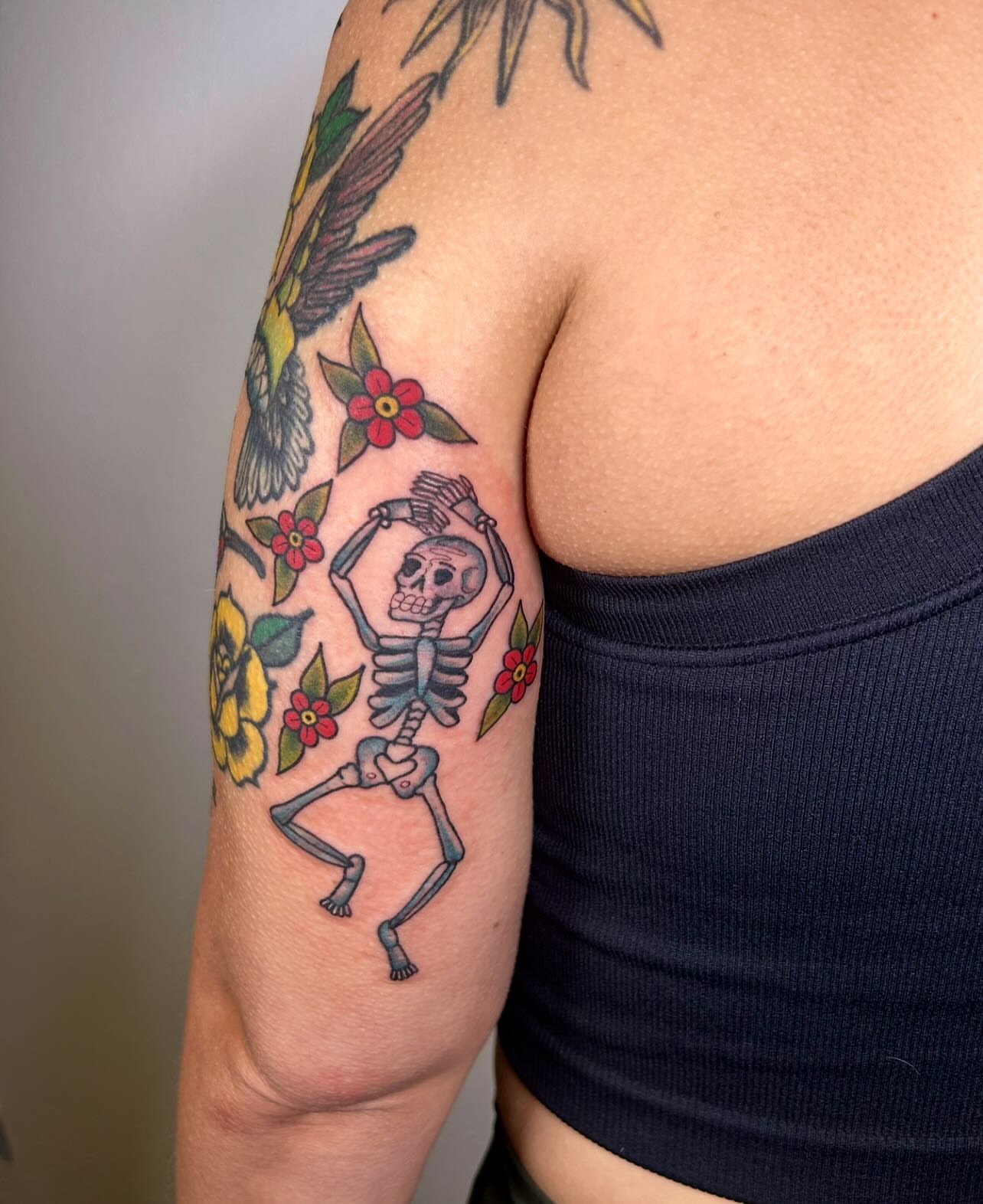 Dancing skeleton American traditional tattoo on the upper arm by ๐ Michelle ๐