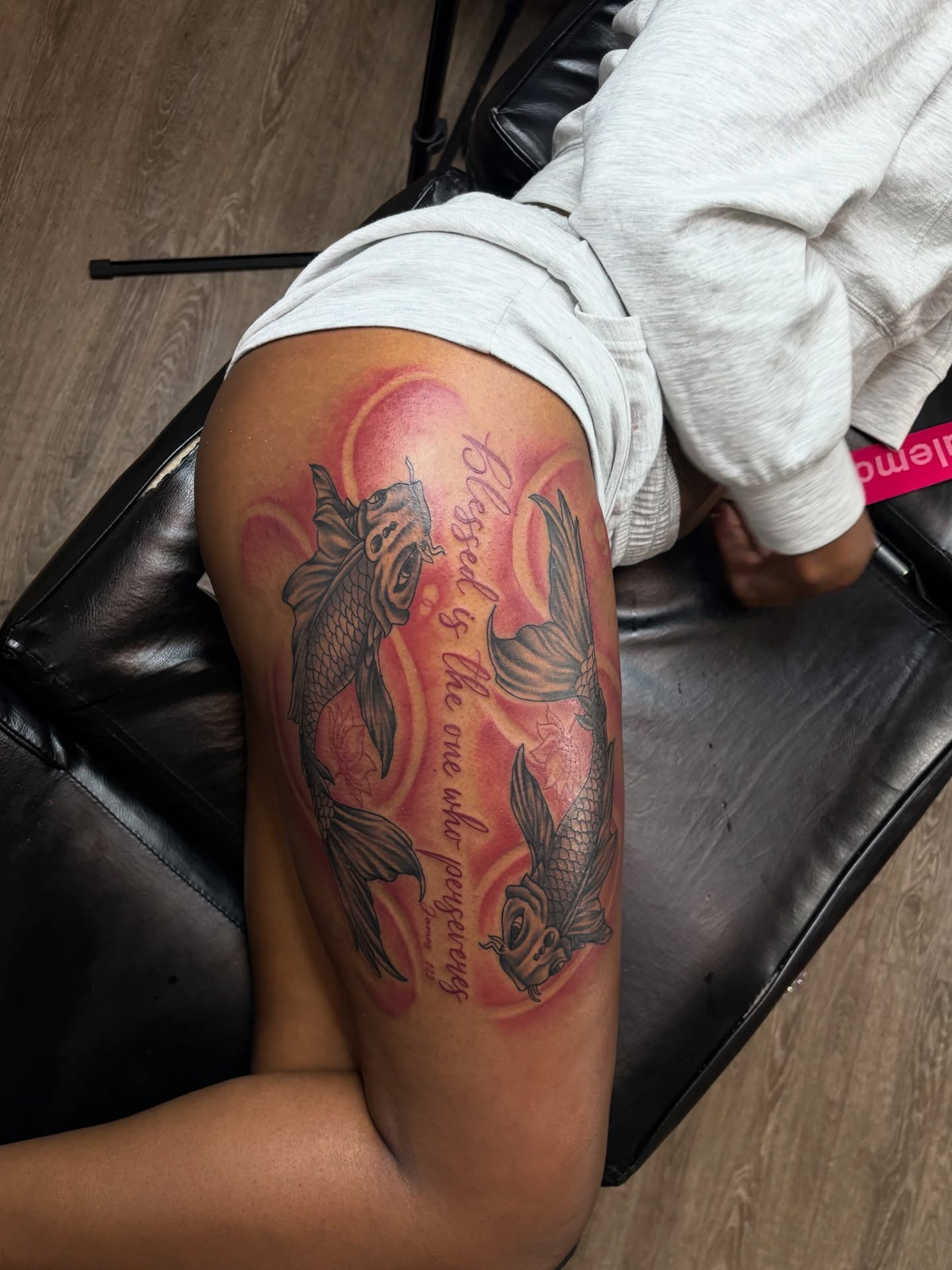 Koi fish and script American traditional tattoo on the thigh by Vonte Seay