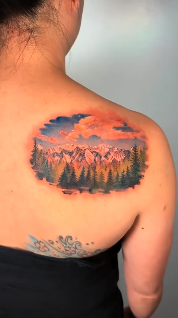 Mountain range with trees and sky realism tattoo by Stephanie Shortsleeve