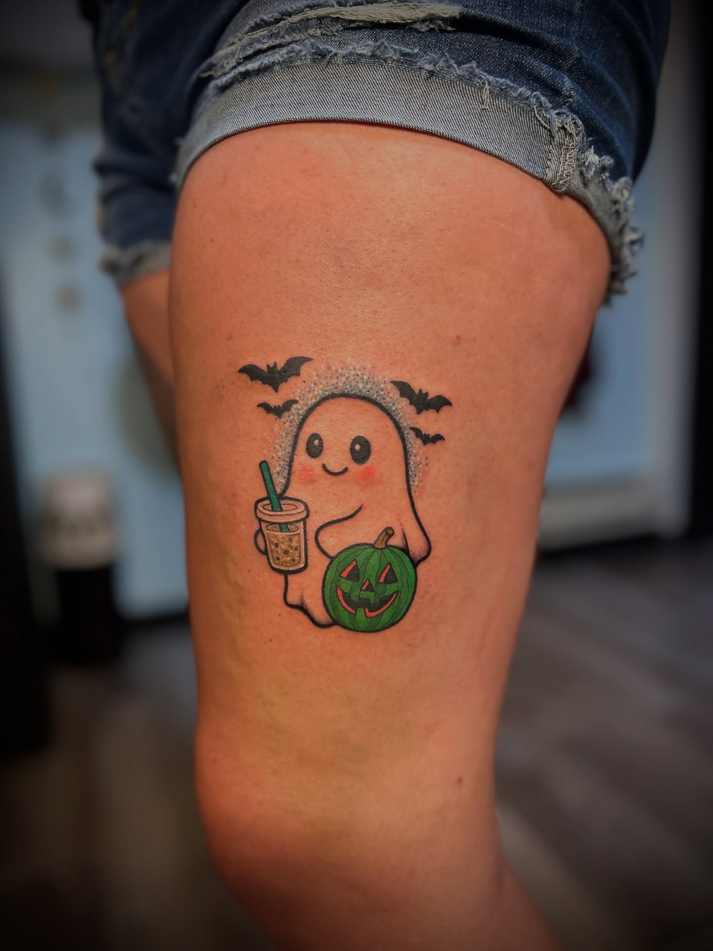 Ghost with pumpkin and drink dotwork tattoo on the thigh by Kiersten Tickle