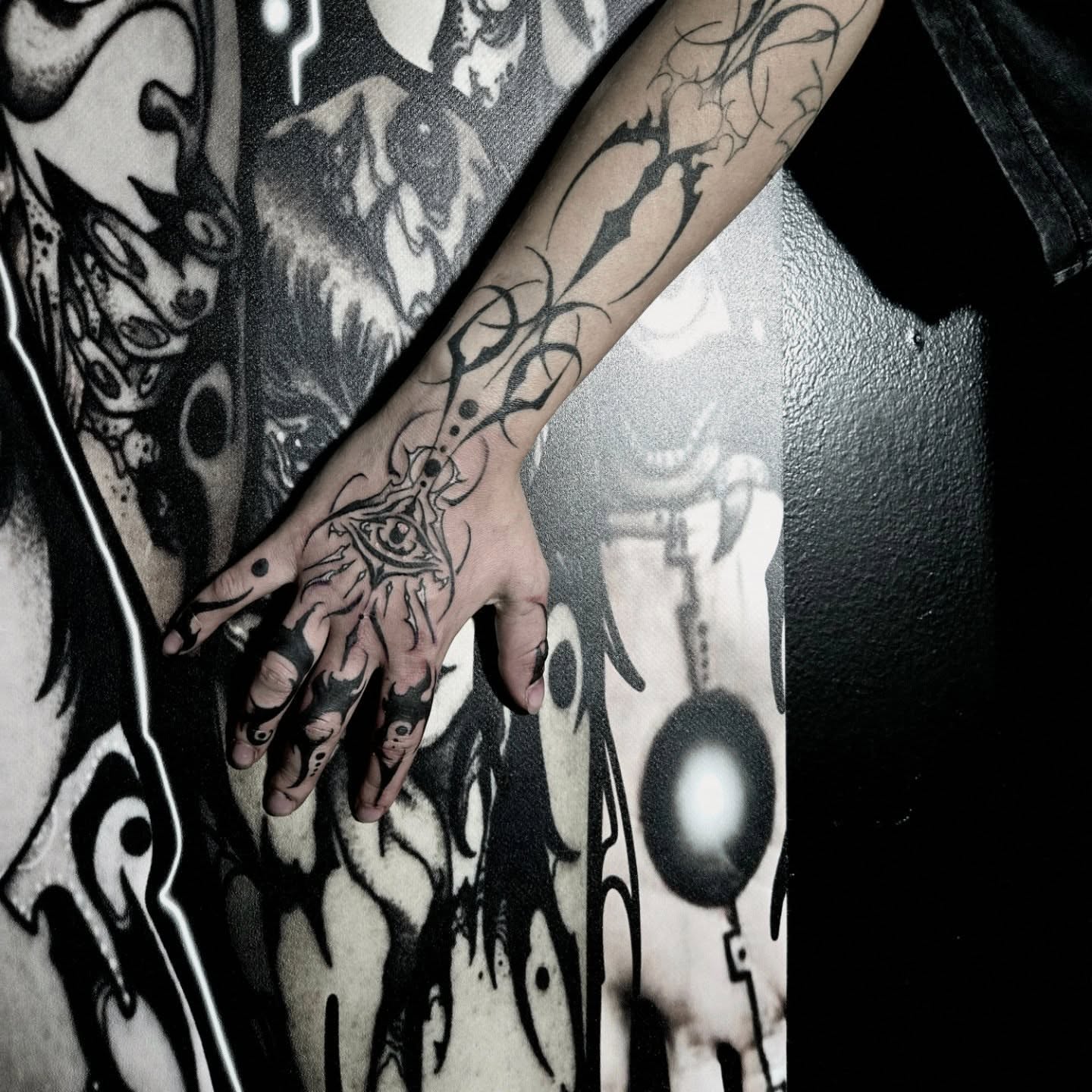 Eye and hand geometric tattoo on the forearm by Ema Fish