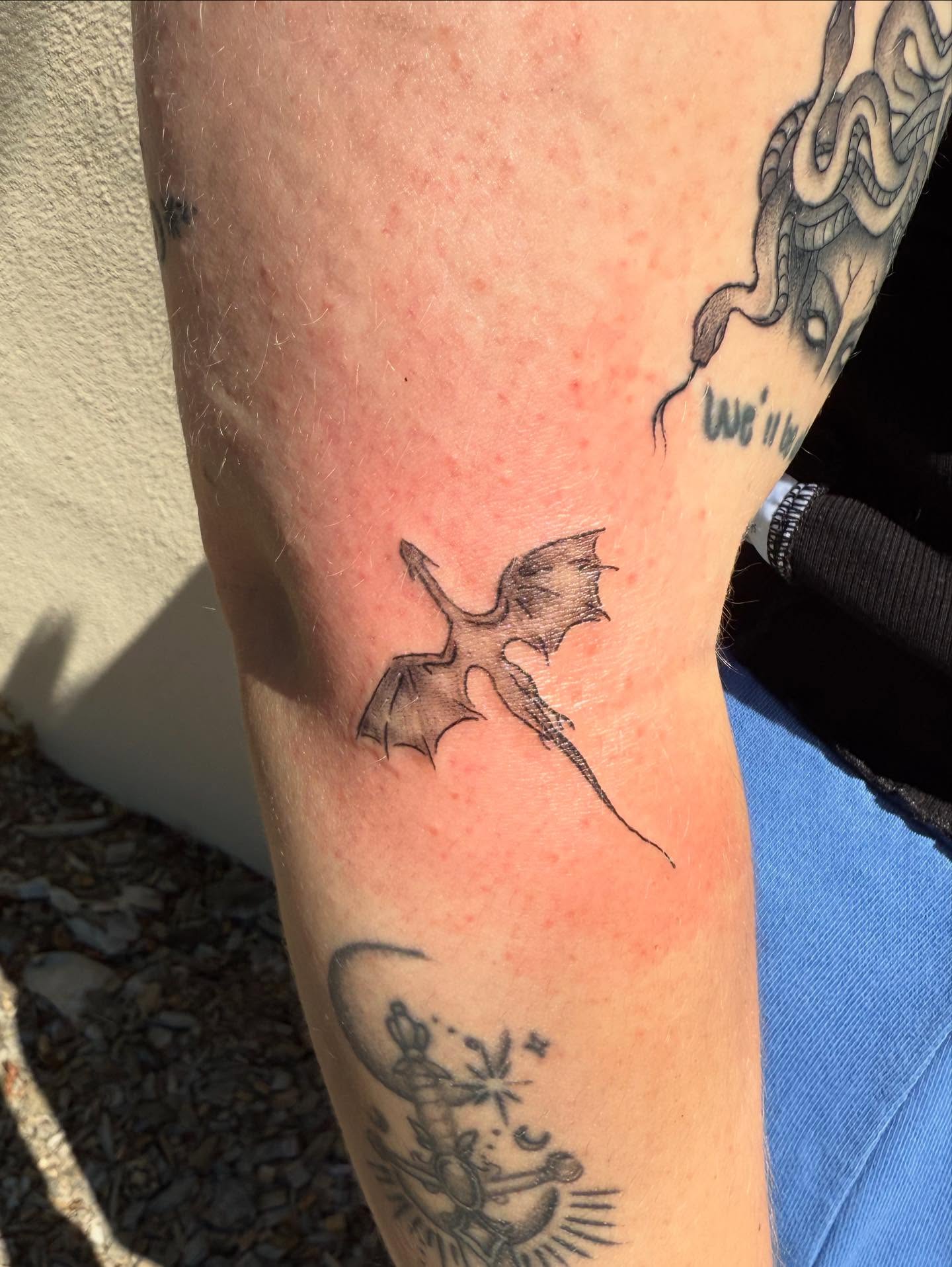 Dragon black and grey tattoo on the forearm by Kylee Snow