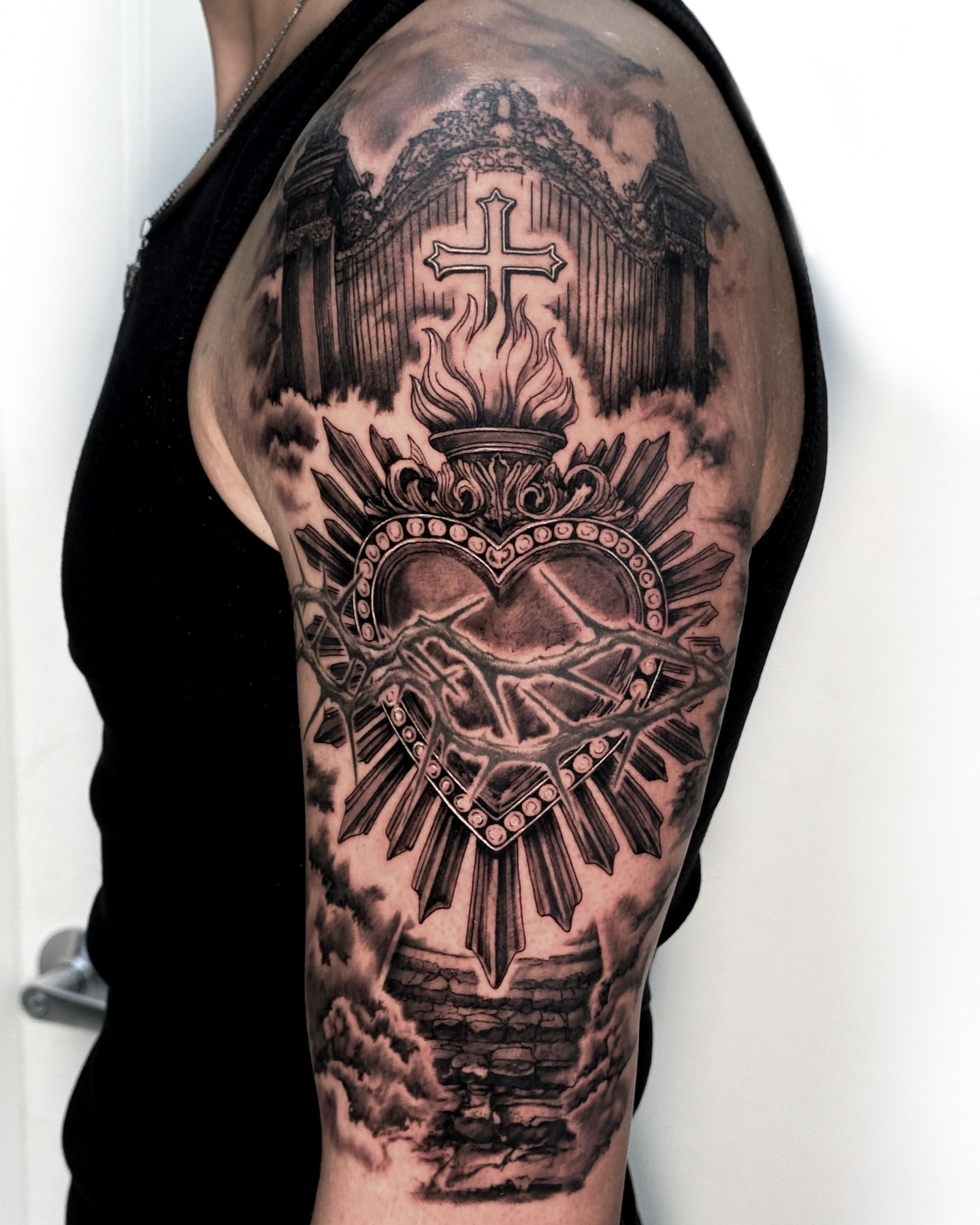 Heart with cross realism tattoo on the shoulder by Luiny