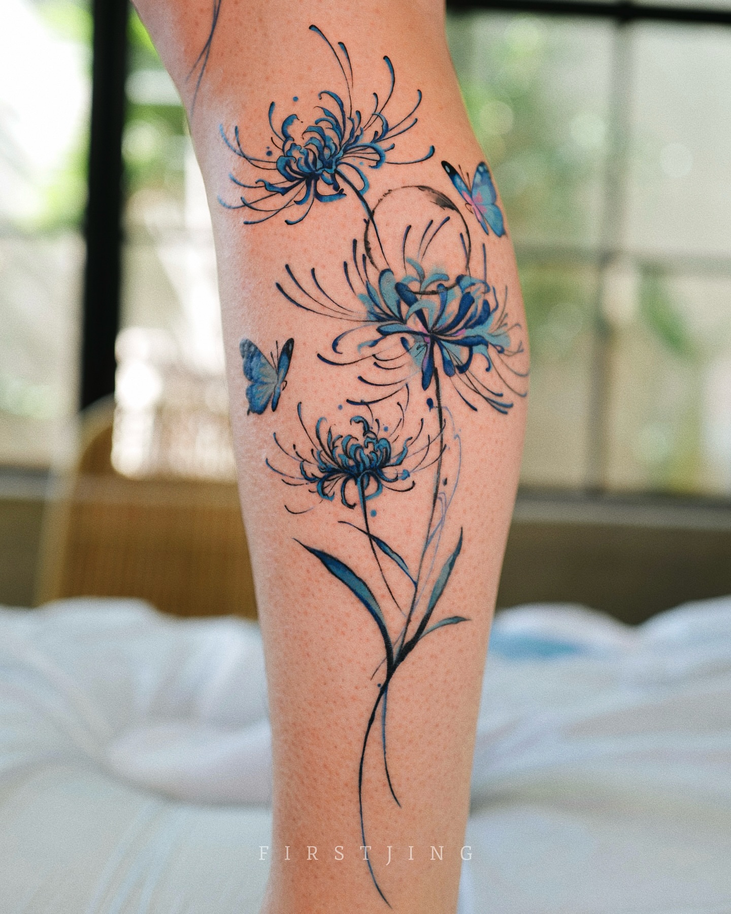 Chrysanthemums and butterflies watercolor tattoo on the calf by Seattle