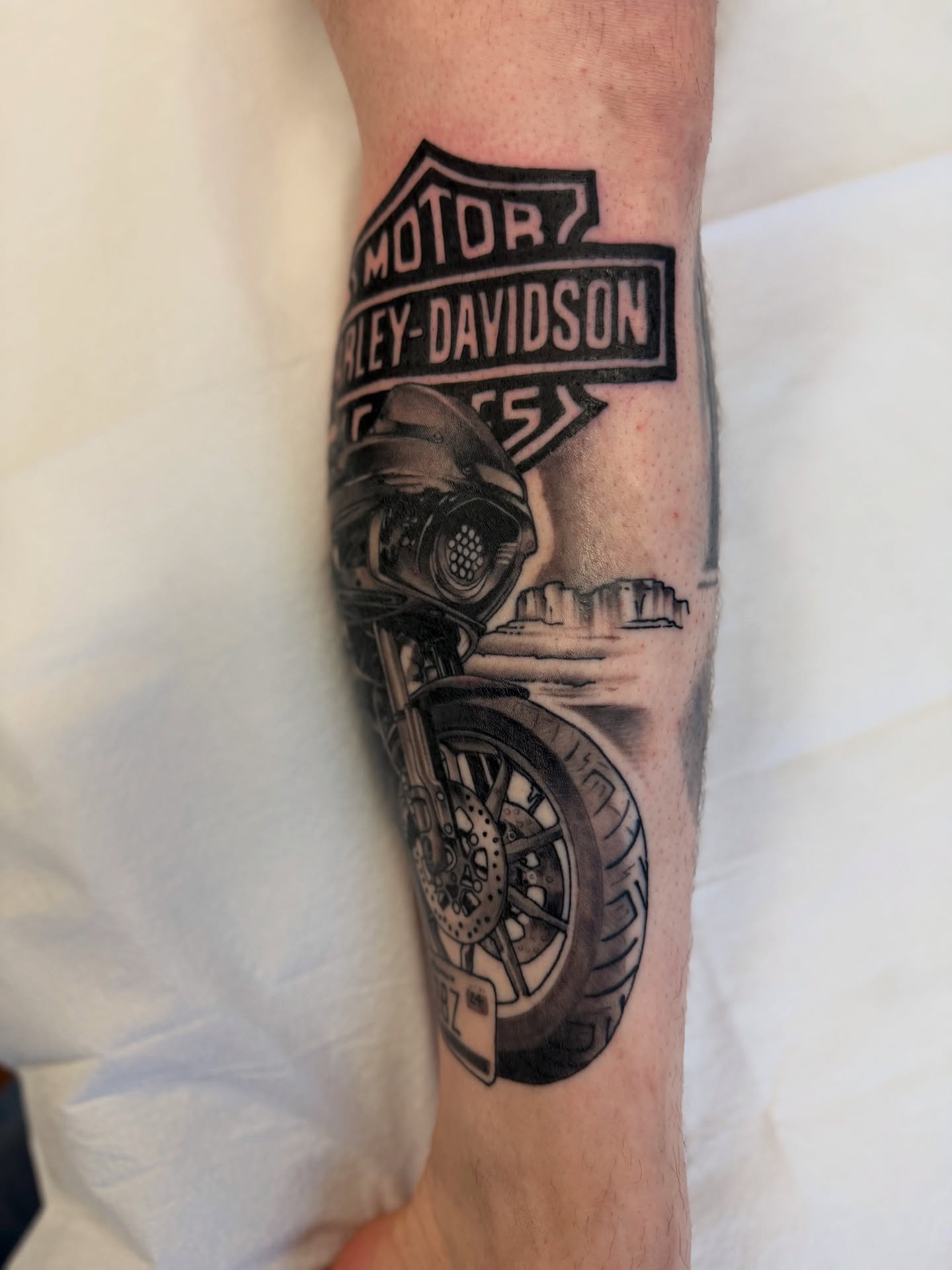 Motorcycle black and grey tattoo on the forearm by Jeremy Utley
