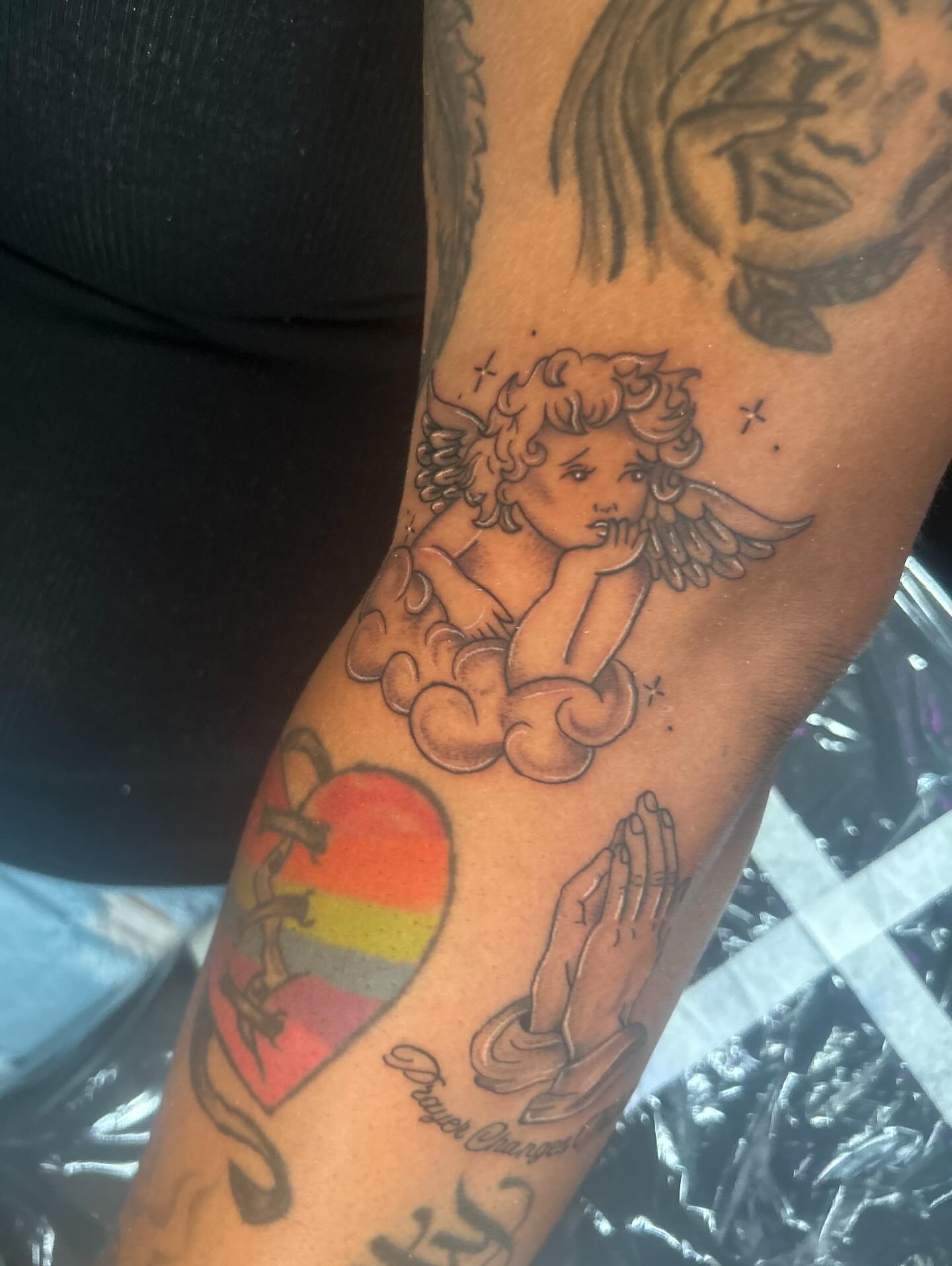 Angel and heart American traditional tattoo on the forearm by Kells