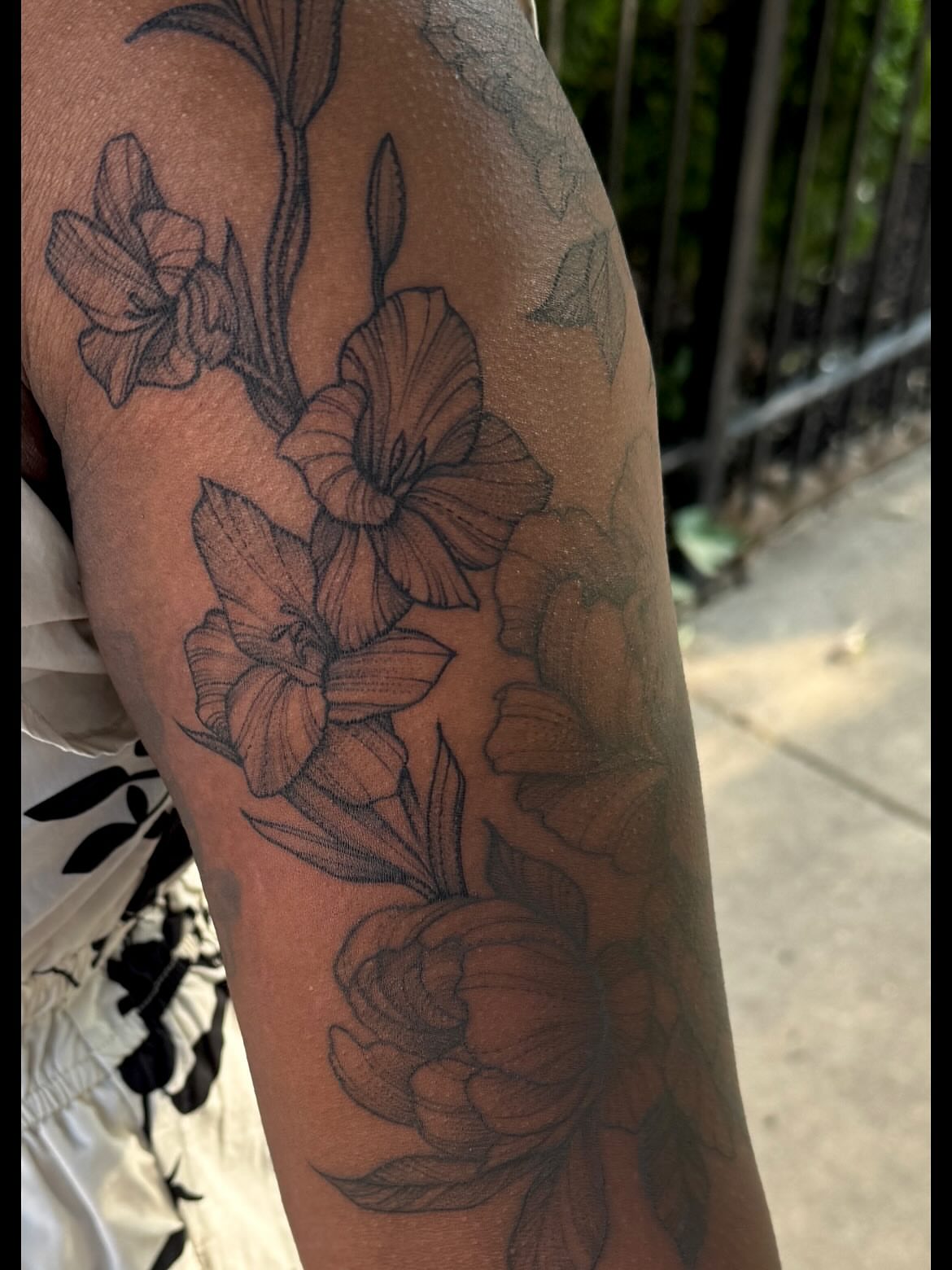 Lilies and peonies realism tattoo on the forearm by Jacob Kearney